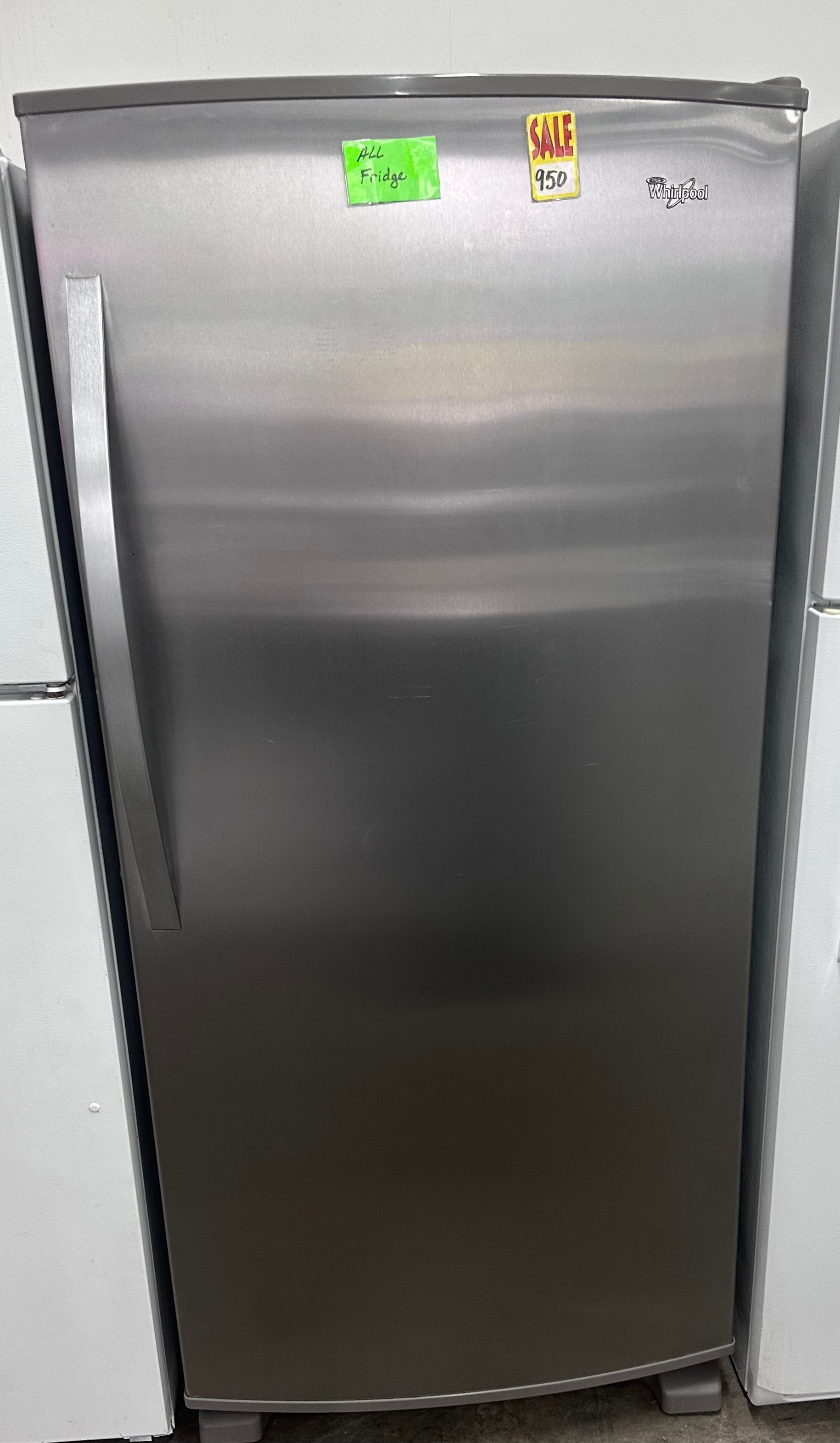 Stainless steel refrigerator with a curved silver door and small stickers near the top.