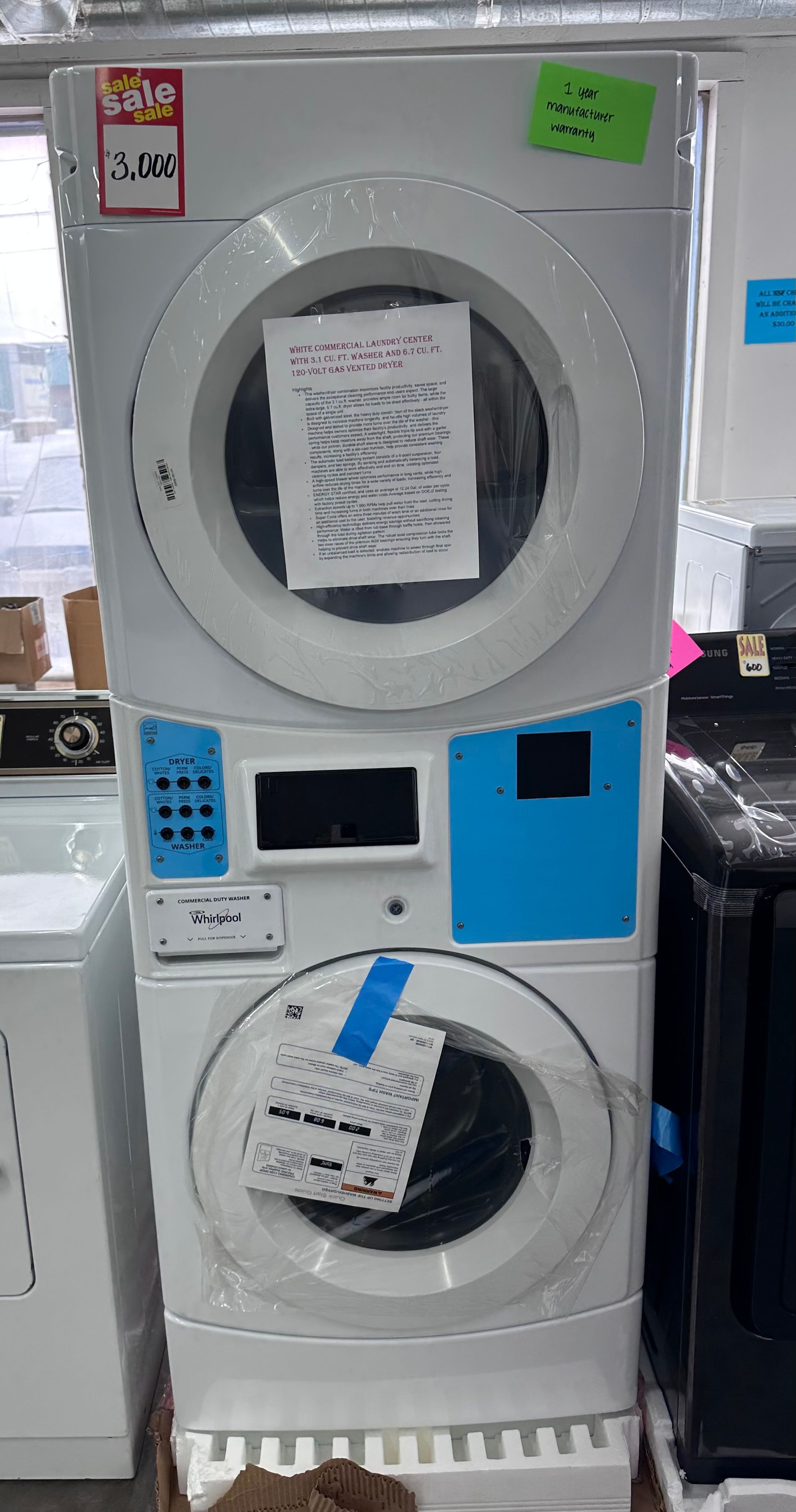 Stacked white Whirlpool washer and dryer appliance with blue accents.