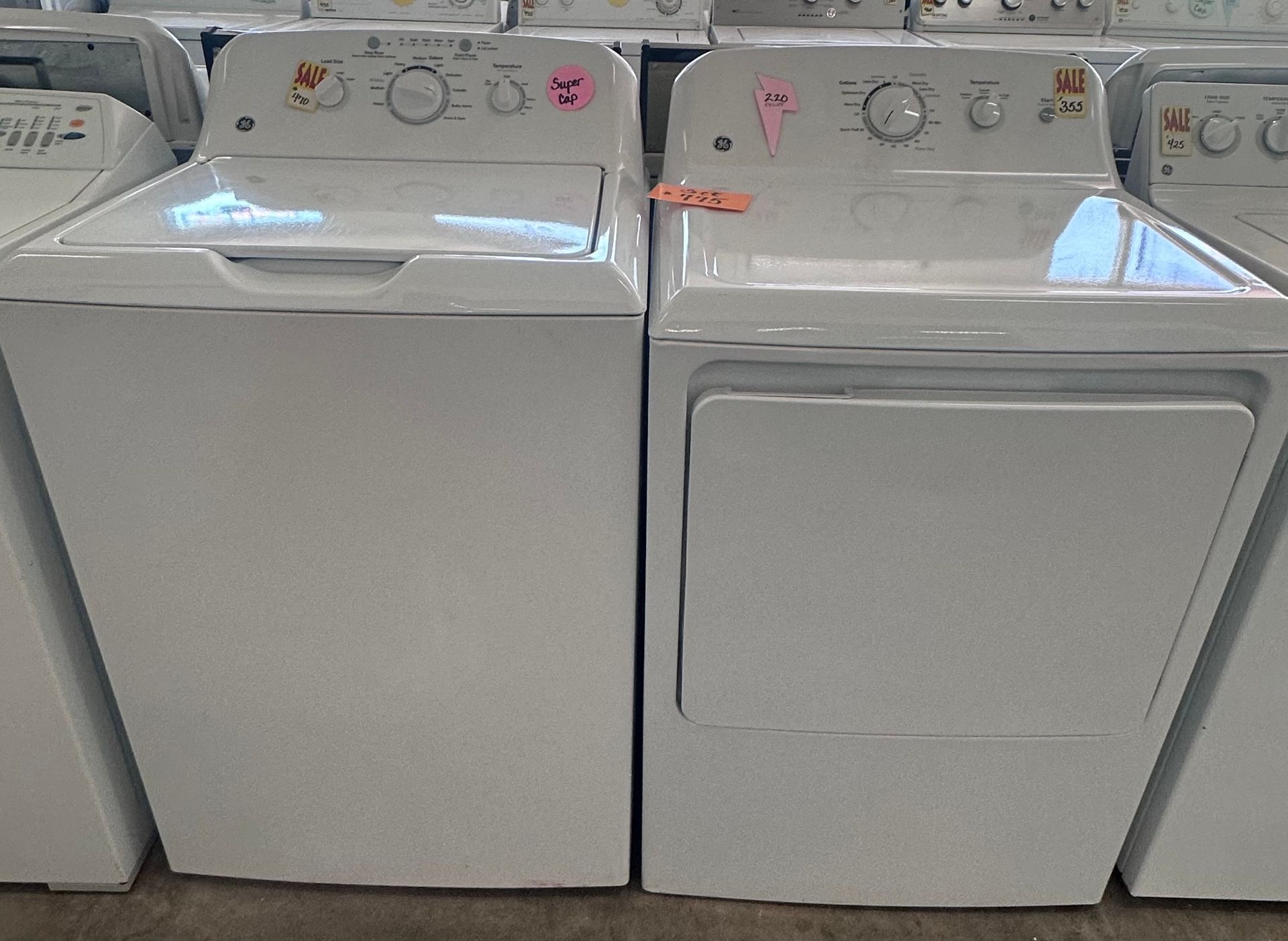 White top-loading washing machine with control panel in a laundry area.