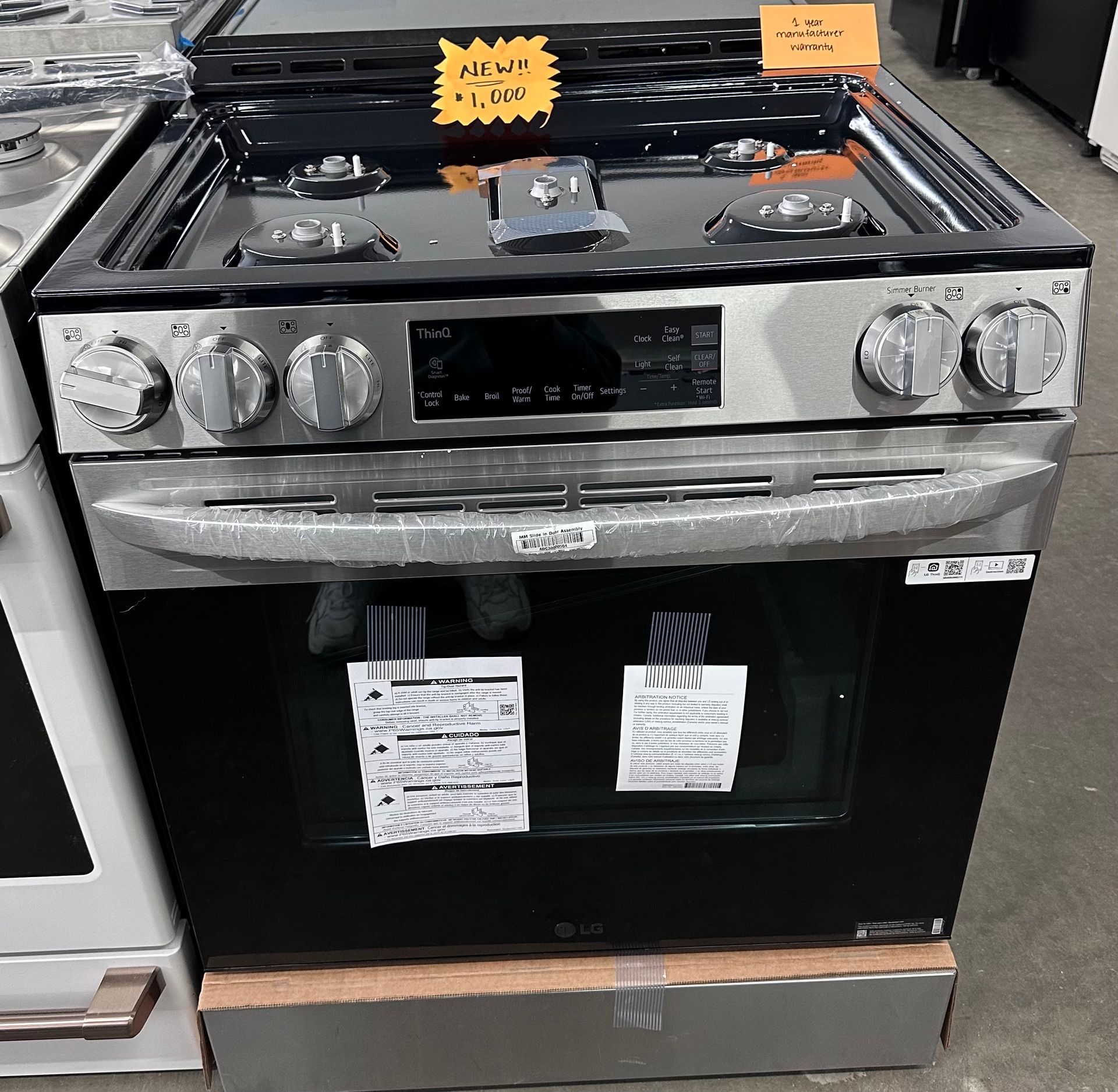 LG stainless steel range with black oven door. Knobs and digital display visible. 