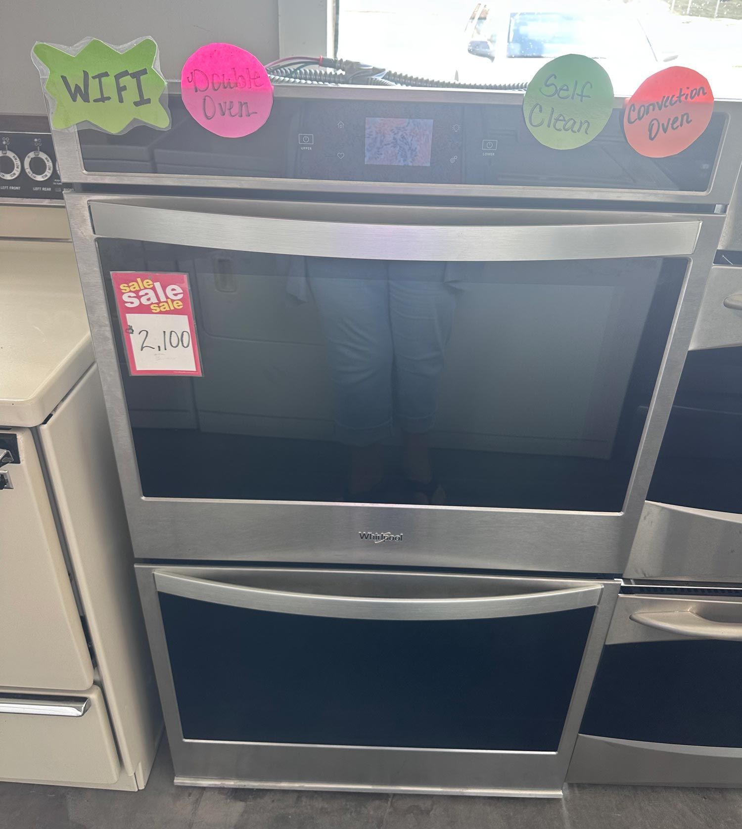 Stainless steel Whirlpool double oven with sale tag, Wi-Fi enabled.