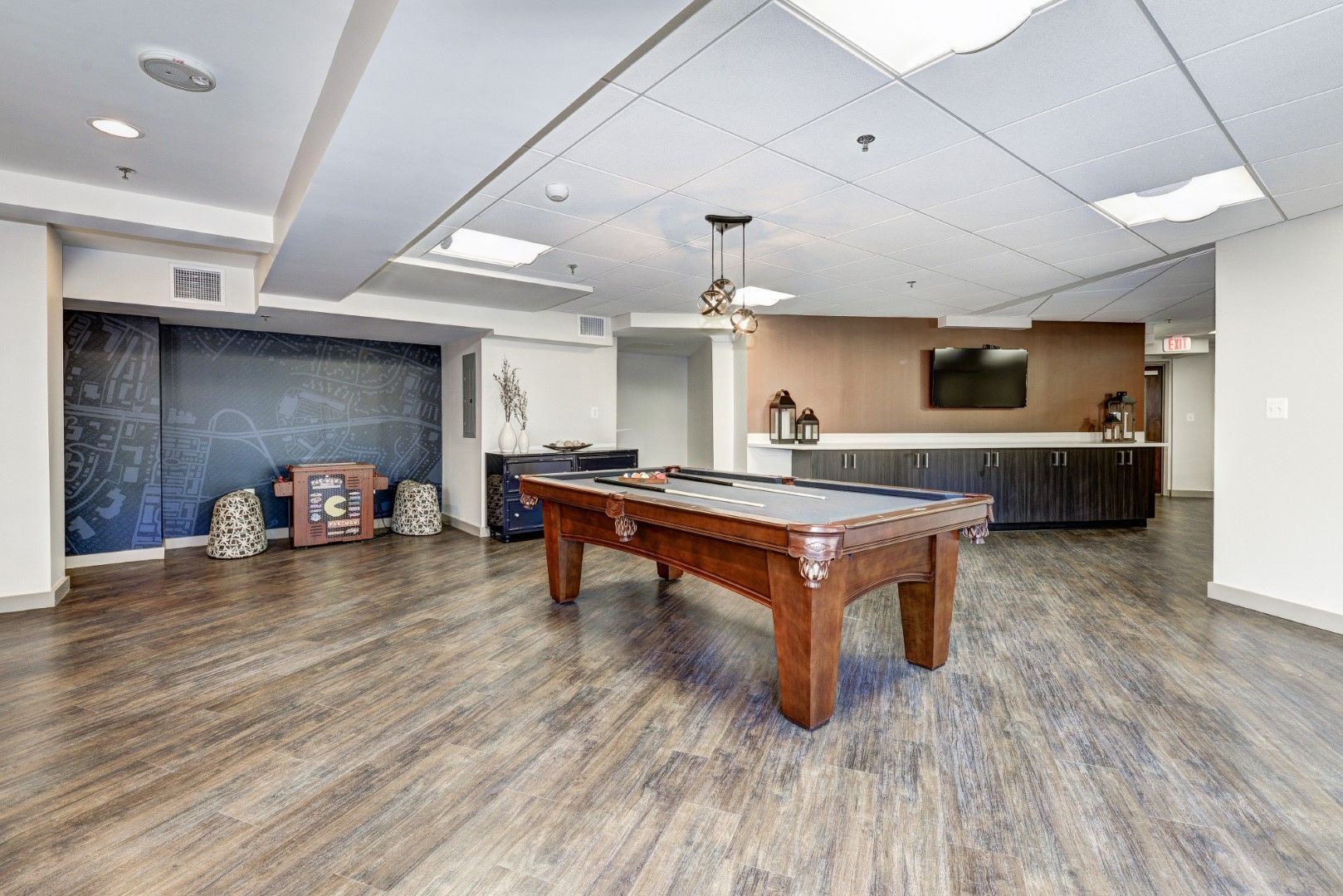 There is a pool table in the middle of the room at The Mark by Solaire in Alexandria, VA.