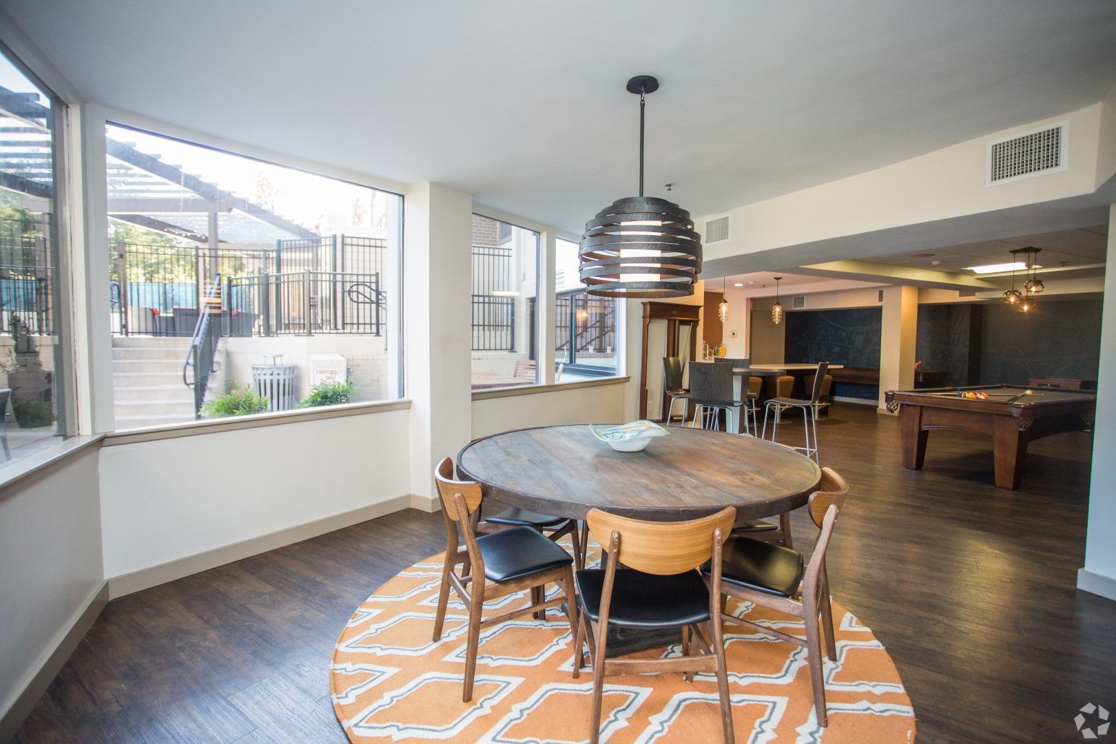 A large room with a table and chairs and a pool table at The Mark by Solaire in Alexandria, VA.