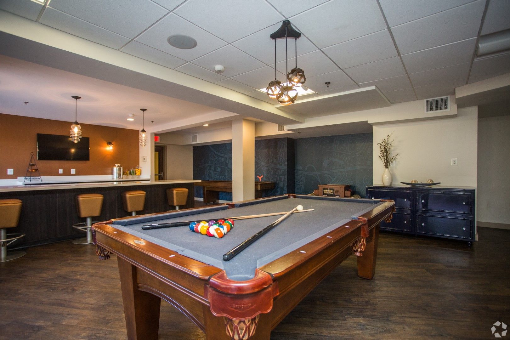 There is a pool table in the middle of the room at The Mark by Solaire in Alexandria, VA.