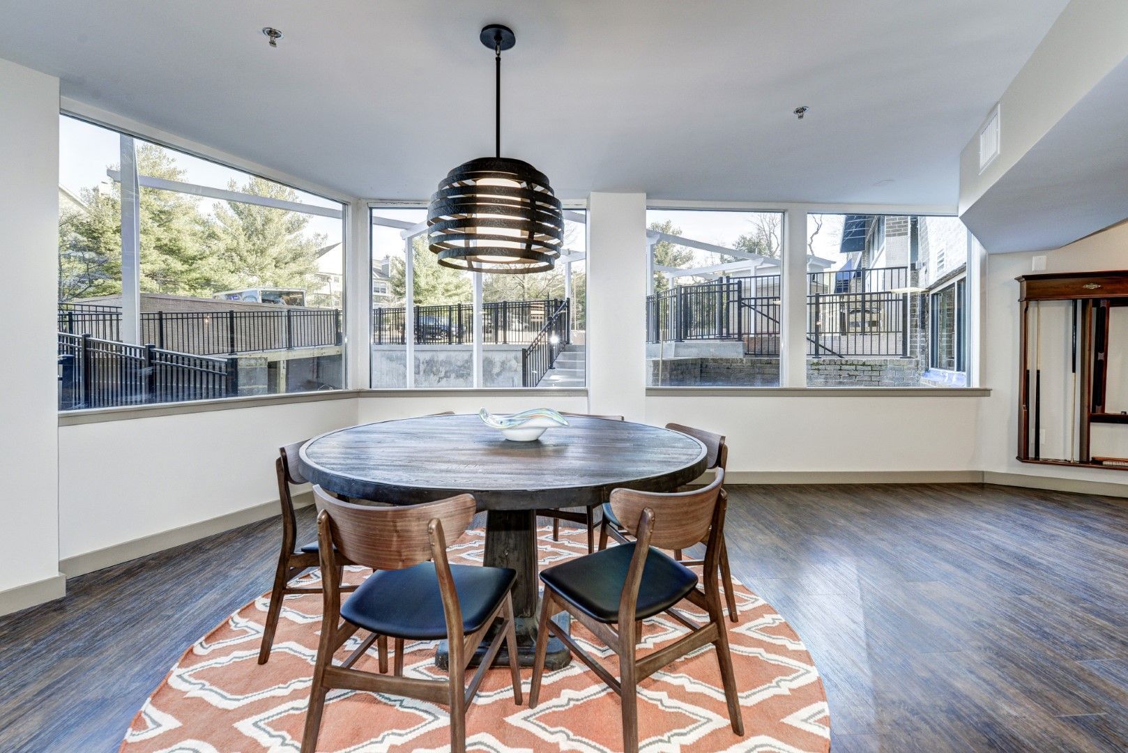 A dining room with a round table and chairs and a rug at The Mark by Solaire in Alexandria, VA.