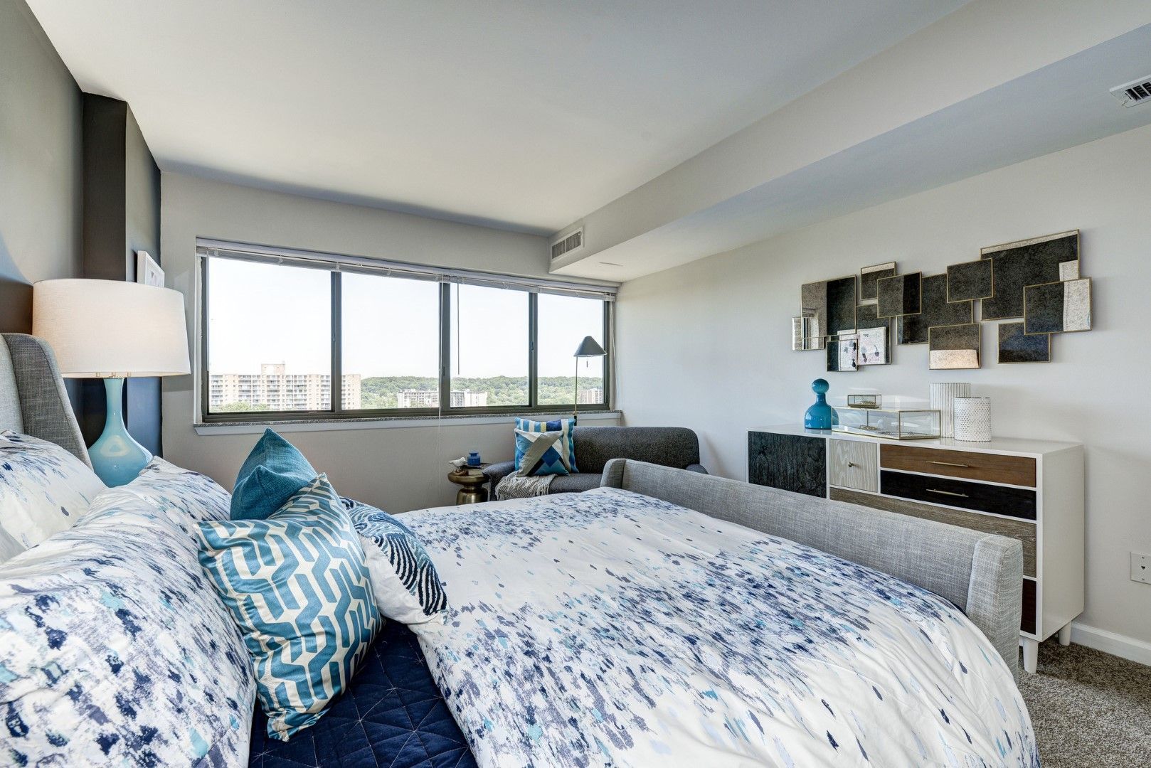 A bedroom with a king size bed and a couch at The Mark by Solaire in Alexandria, VA.
