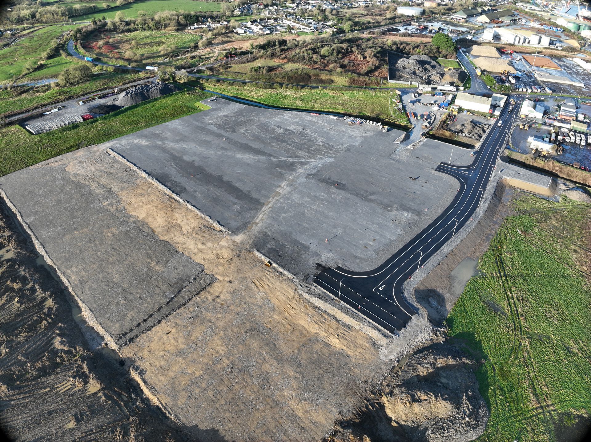 An aerial view of a road going through a field