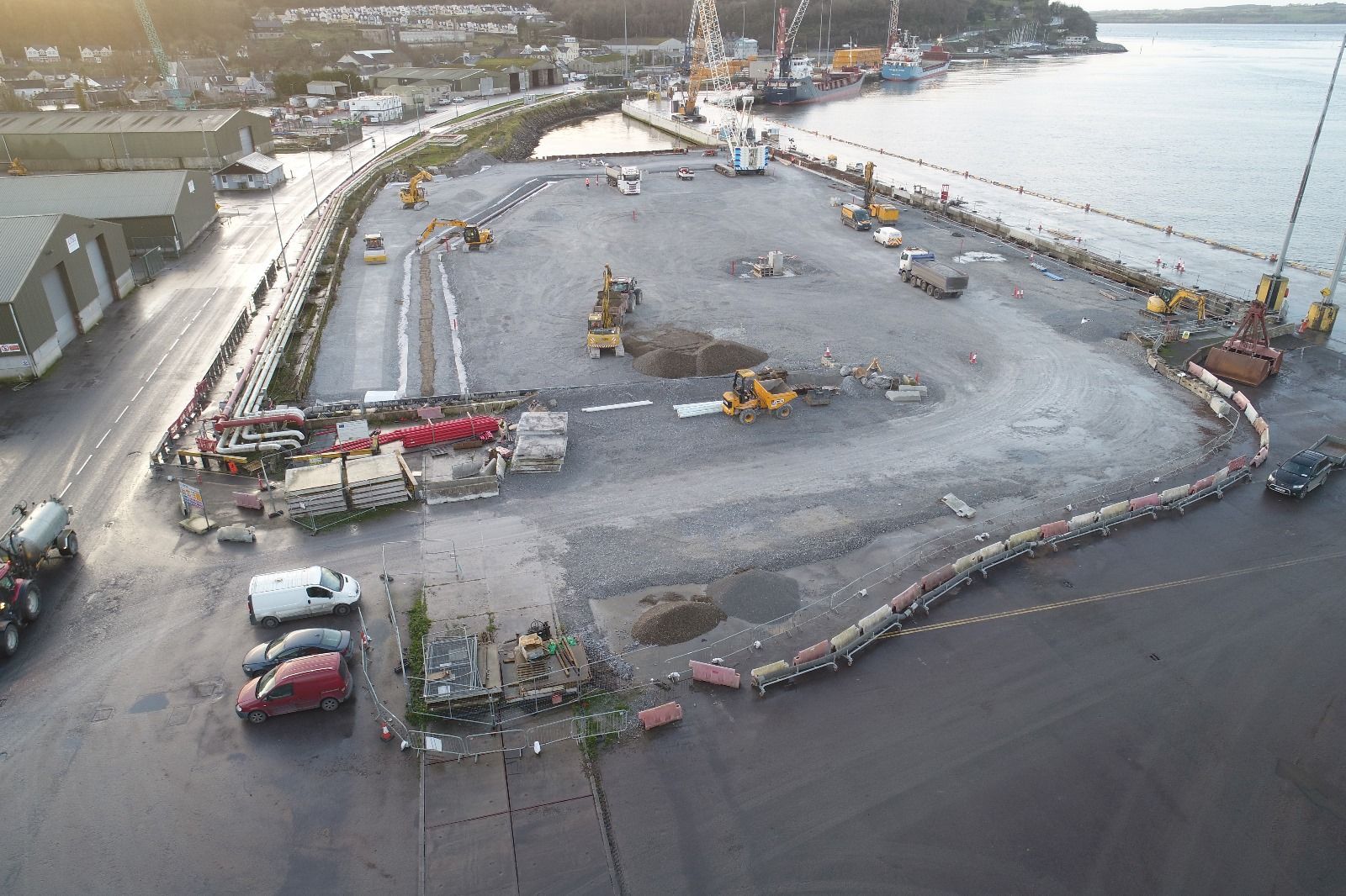 An aerial view of a parking lot next to a body of water