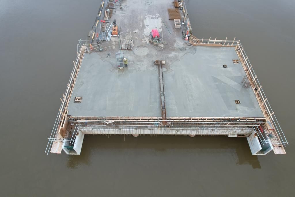 An aerial view of a bridge under construction over a body of water.