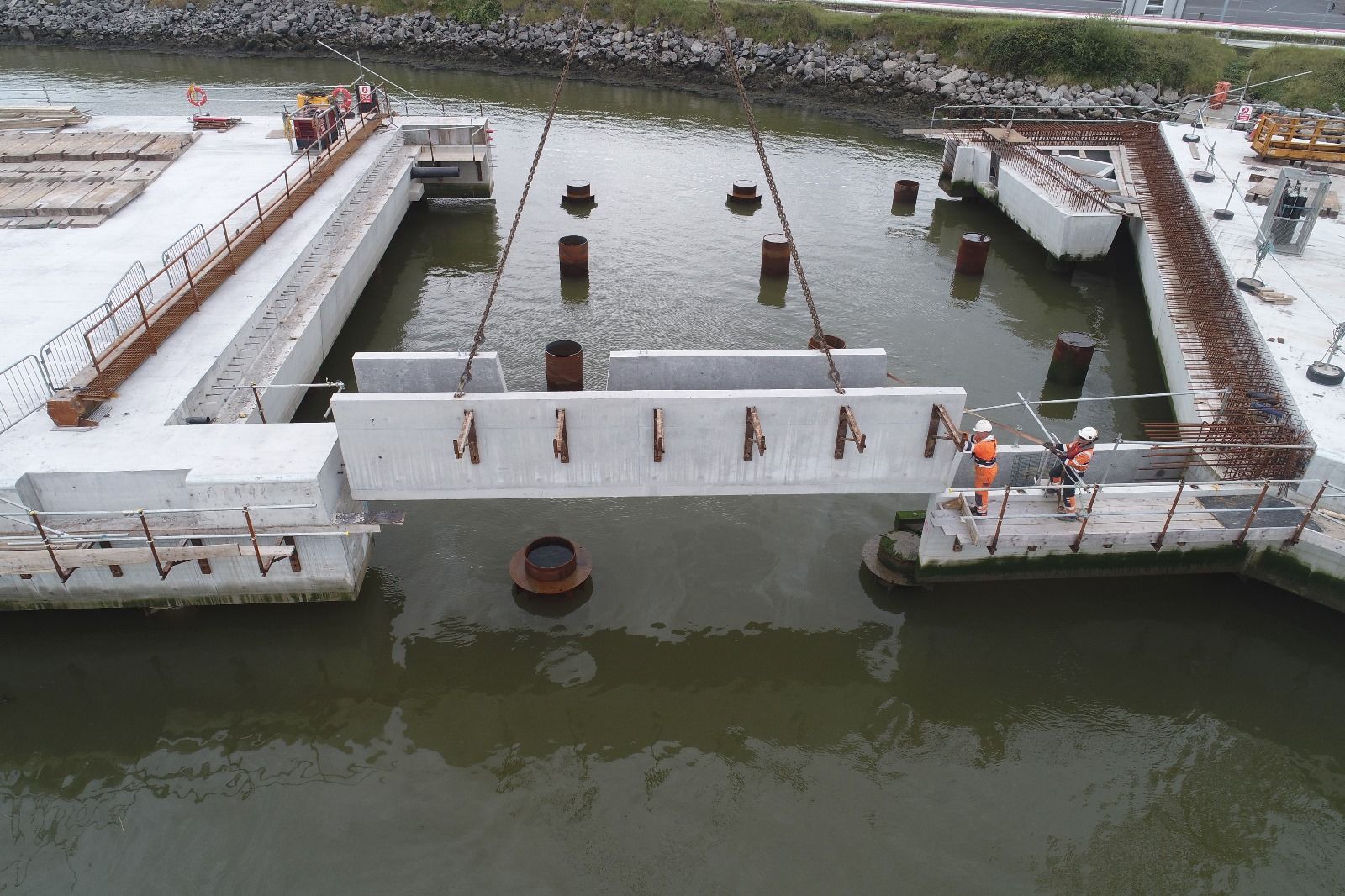 An aerial view of a bridge being built over a body of water