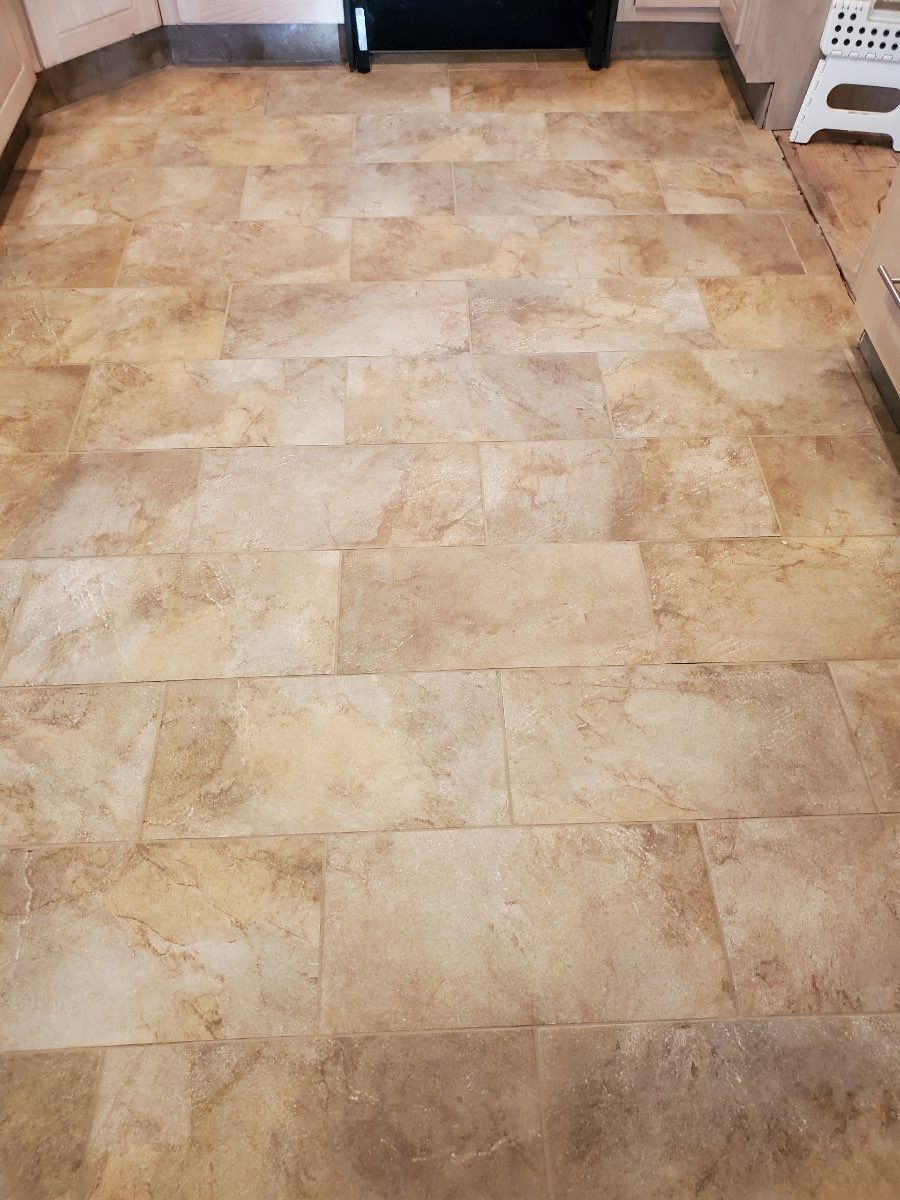 Tiled beige stone floor in a room, viewed from above