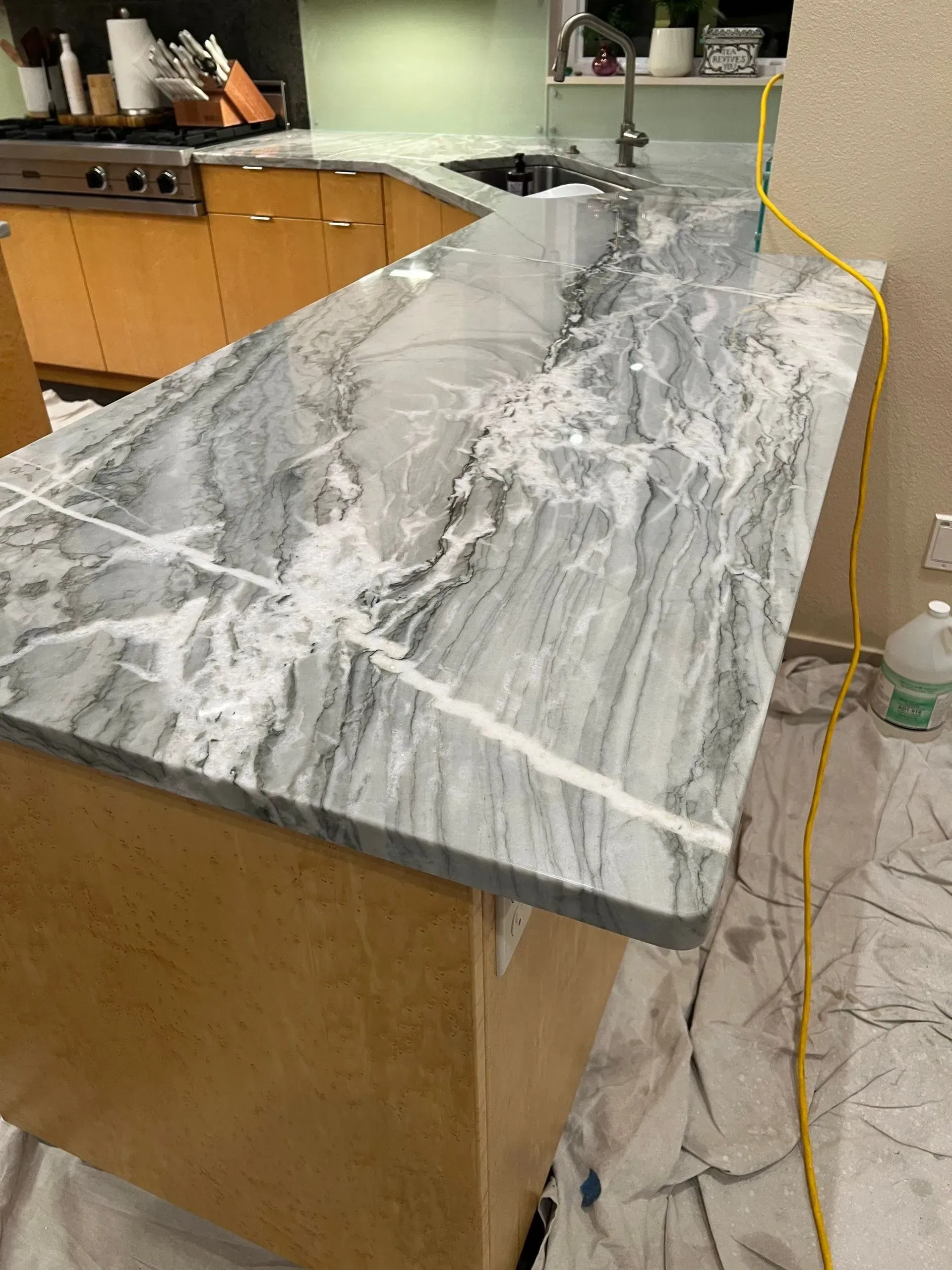 Marble countertop covered with a foamy liquid spill in a kitchen or lab workspace