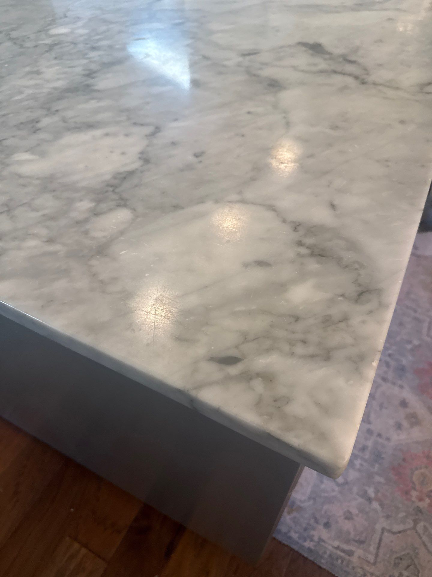 White double-sink bathroom vanity with mirror and marble floor tiles.