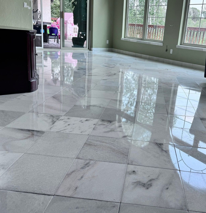 Marble kitchen island with pendant lights reflecting on its glossy surface in a modern home interior