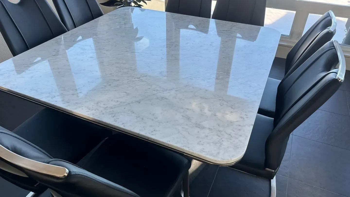 Empty conference table with black chairs in a bright meeting room