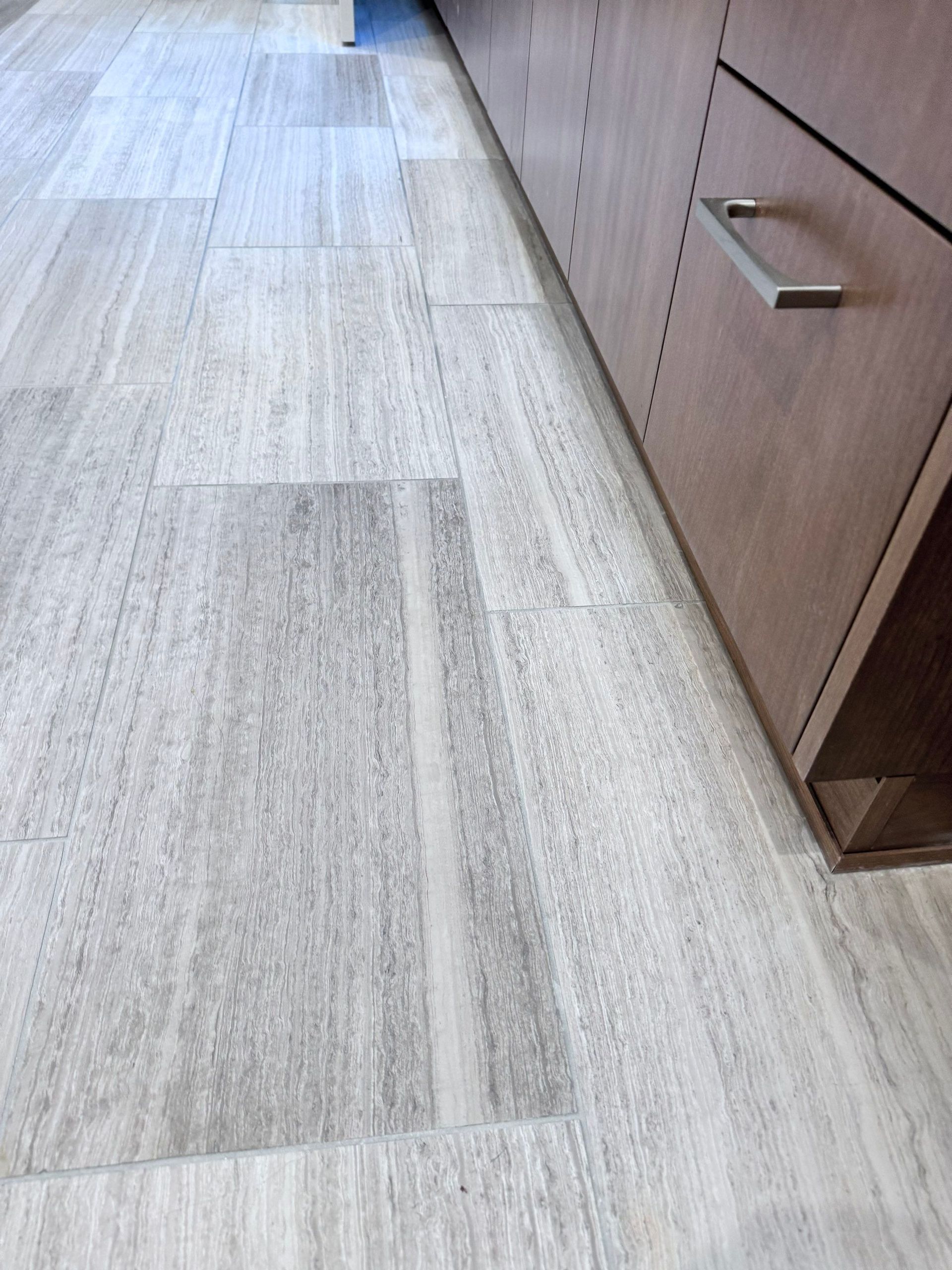 Light wood floor with a cabinet along the right side and a clear hallway-like space.