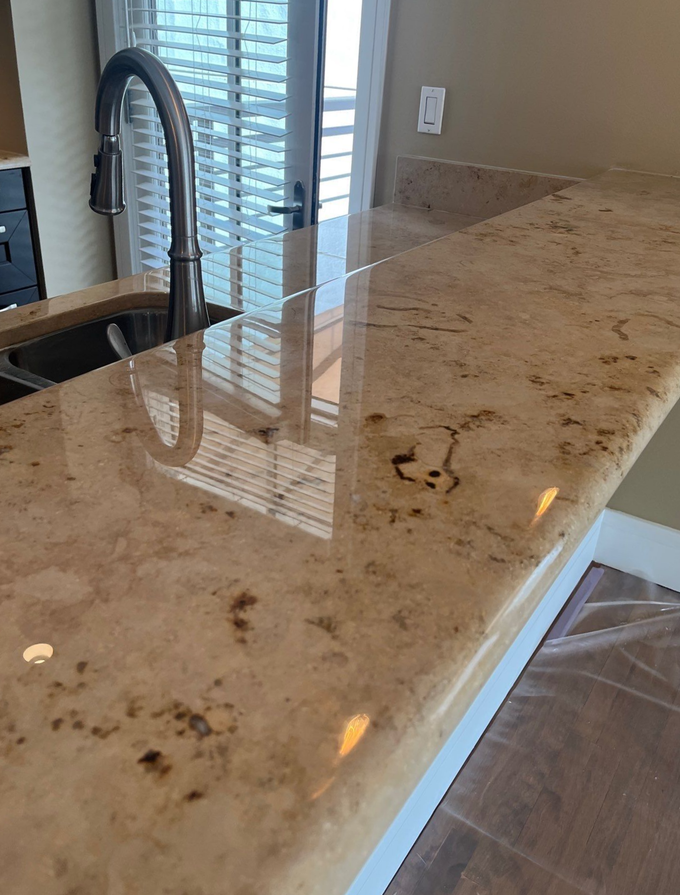 Glossy light wood table with a window reflection