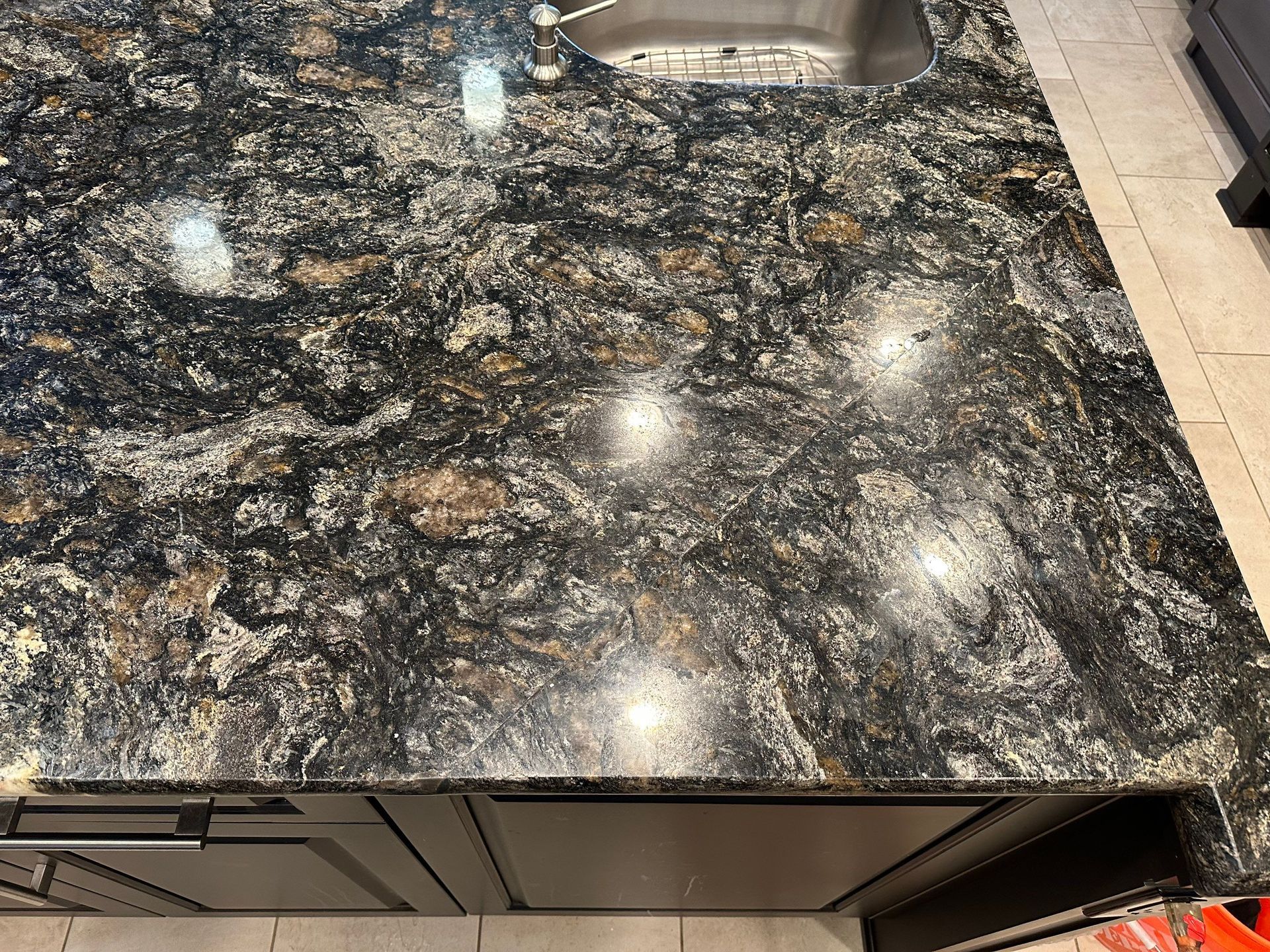Dark marble tabletop with bright reflections in a café or kitchen setting