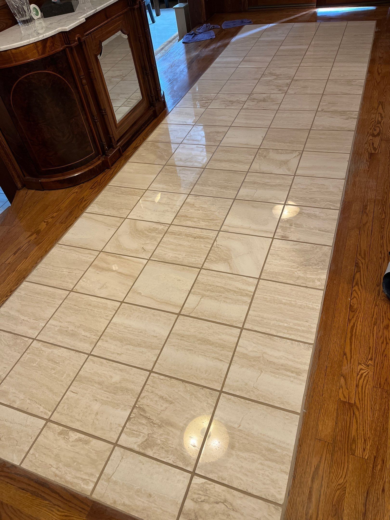Narrow kitchen hallway with light tile floor and a front-loading washer on the right.