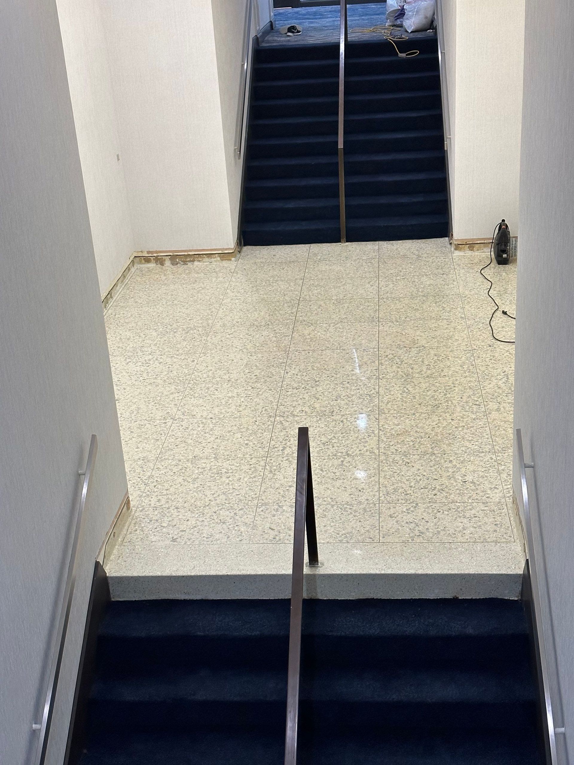 Indoor tiled floor with two chairs and part of a table visible near the top right.