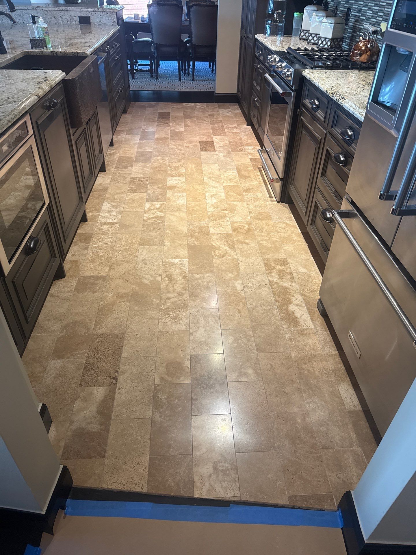 Indoor tiled floor with two chairs and part of a table visible near the top right.