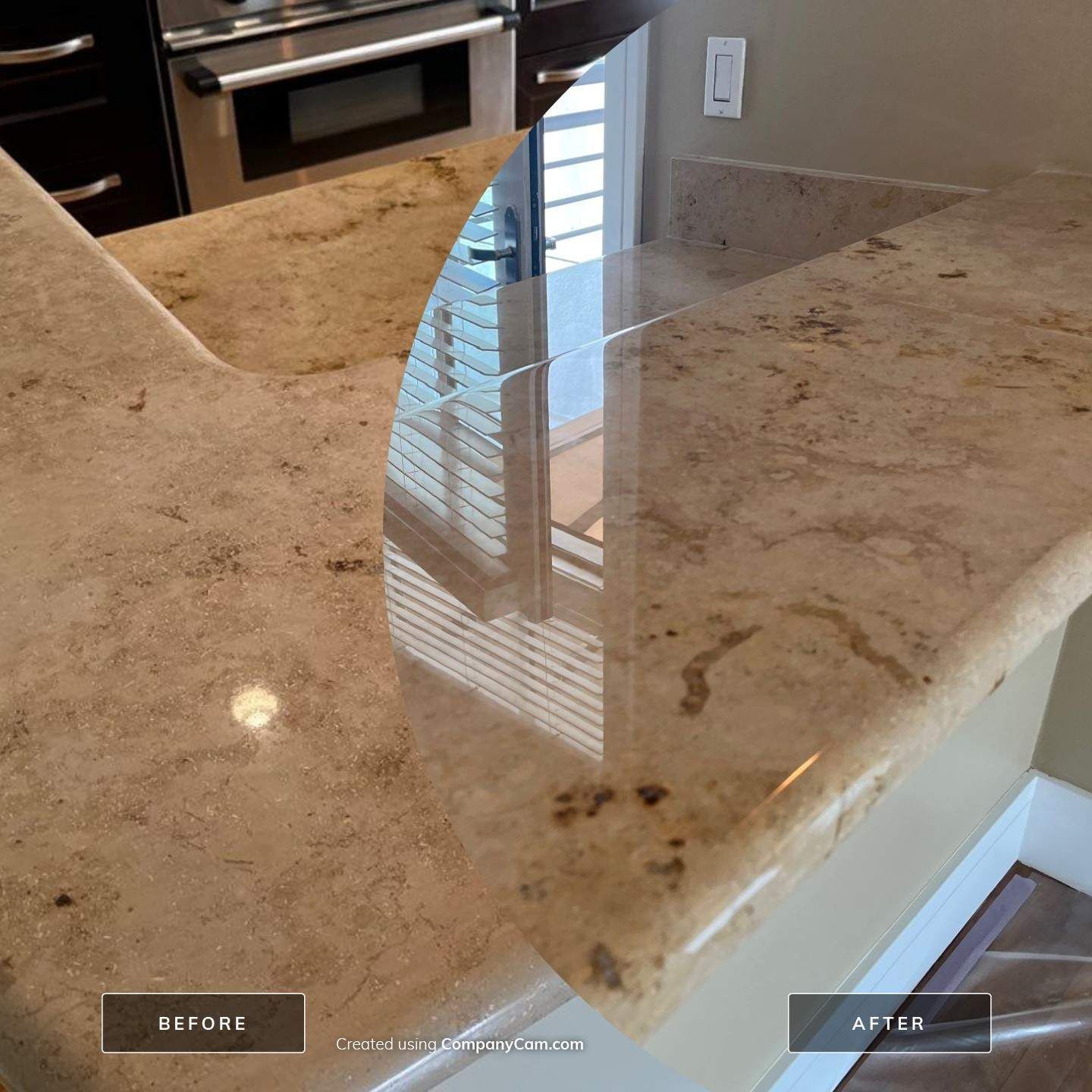 Modern kitchen with a large marble island countertop and light cabinetry in the background