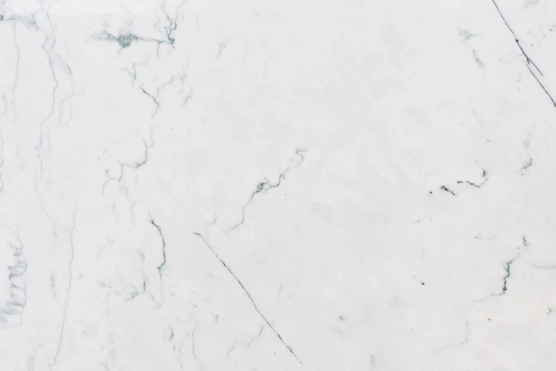 White marble surface with subtle gray veining.