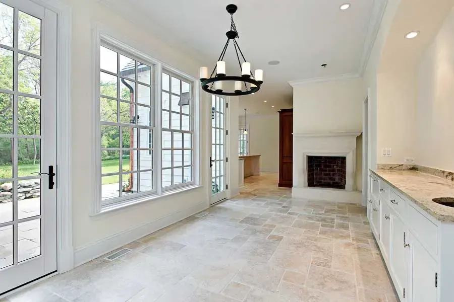 White double-sink bathroom vanity with mirror and marble floor tiles.