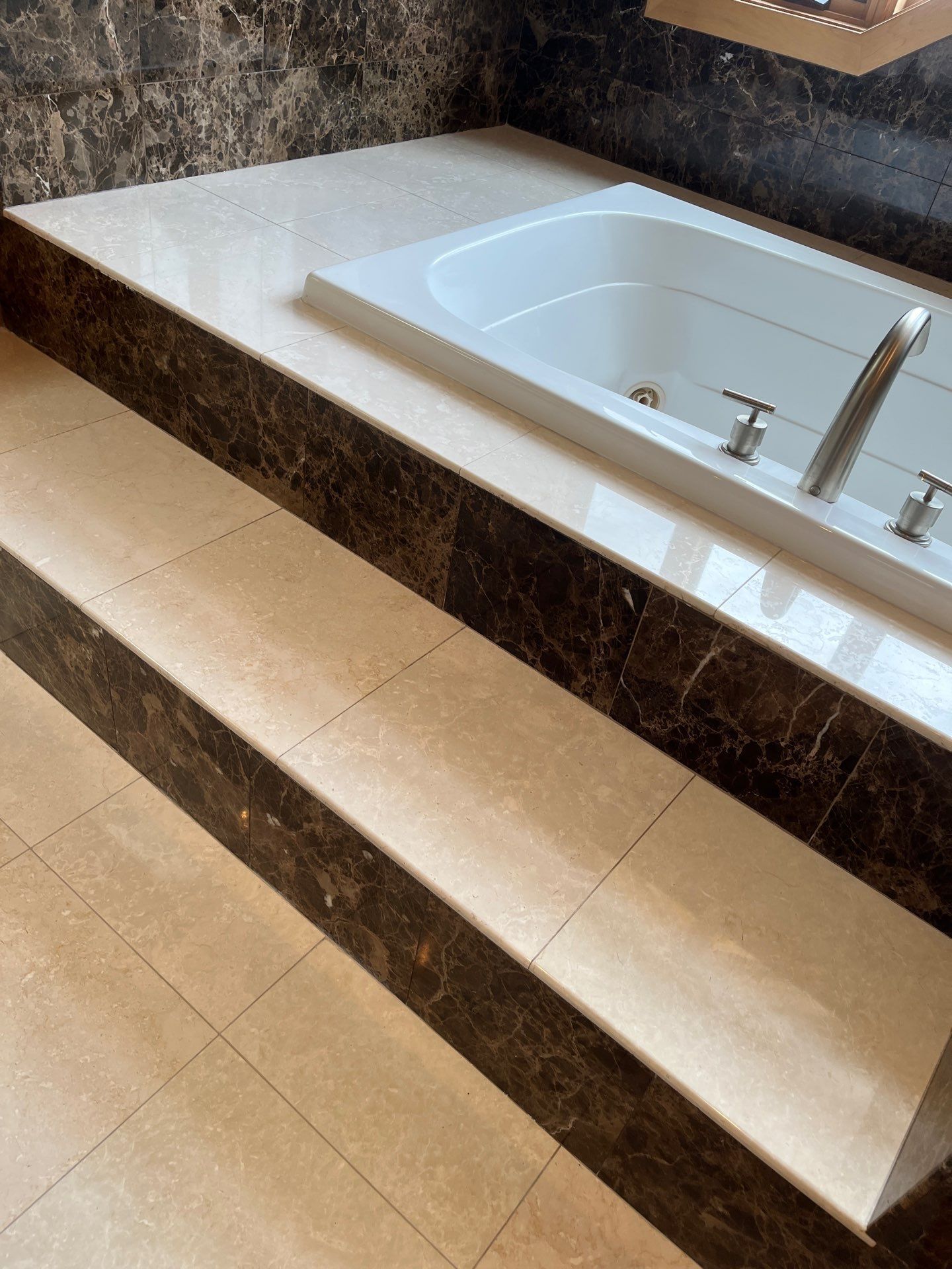Tiled shower with wall-mounted showerhead, soap dish, and recessed shelf niche