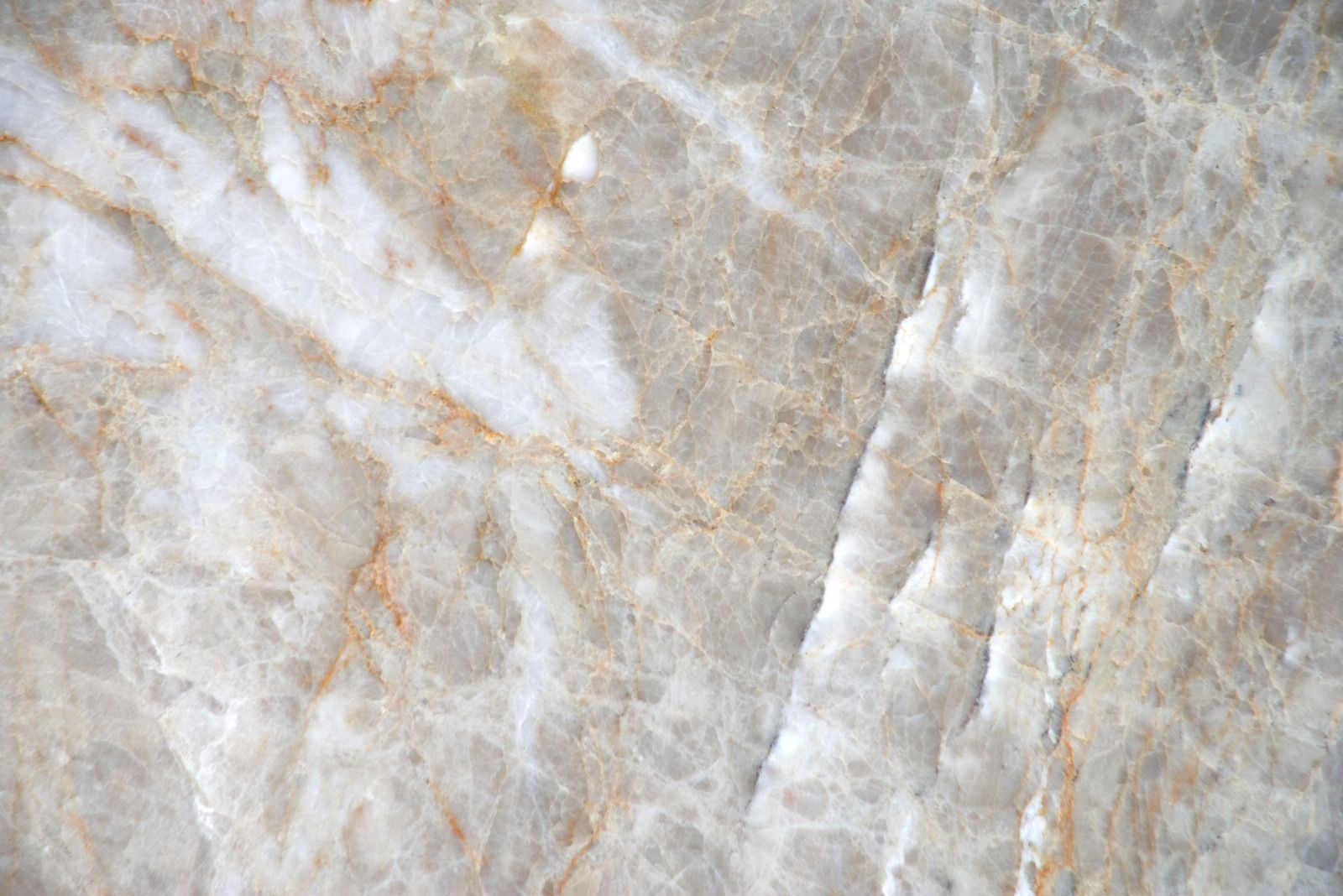 Kitchen counter with a marble-patterned surface and a dish rack in the background.