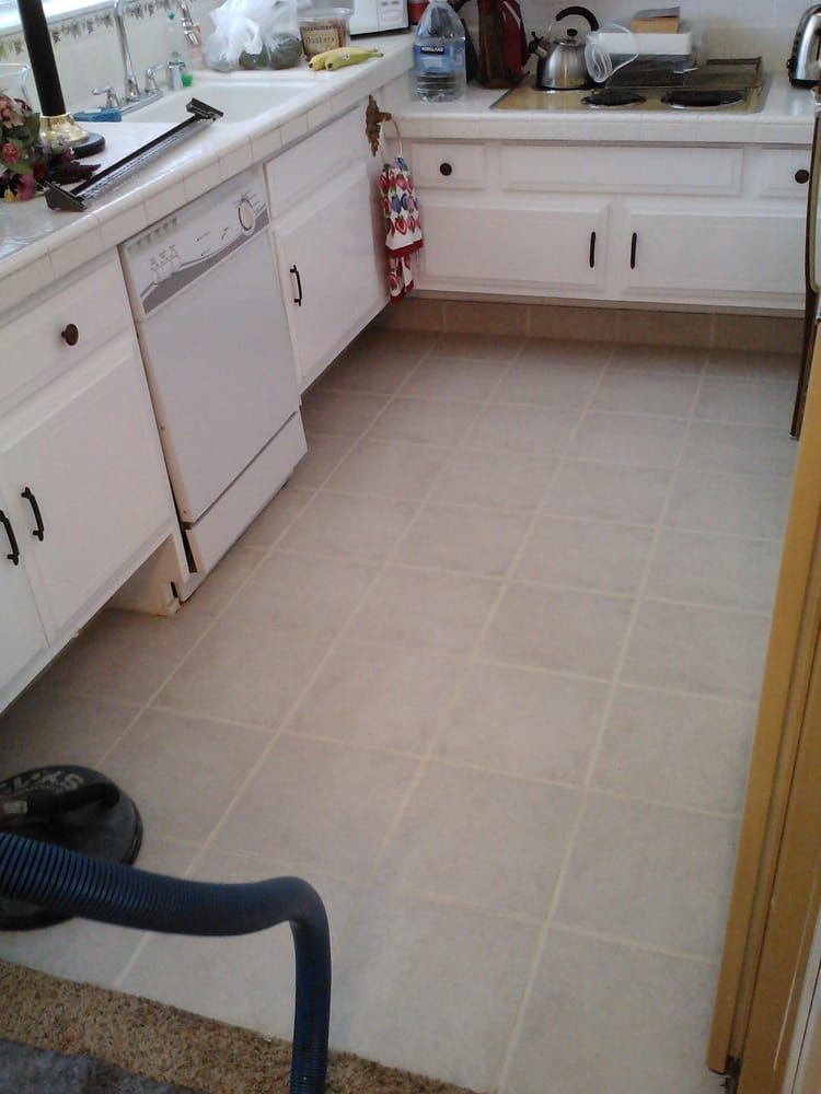 A kitchen with white cabinets and a dishwasher
