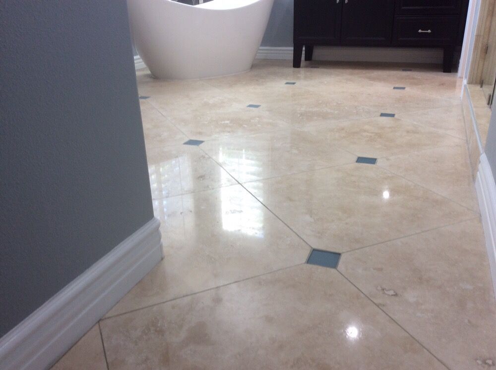 A bathroom with a bathtub and a tiled floor