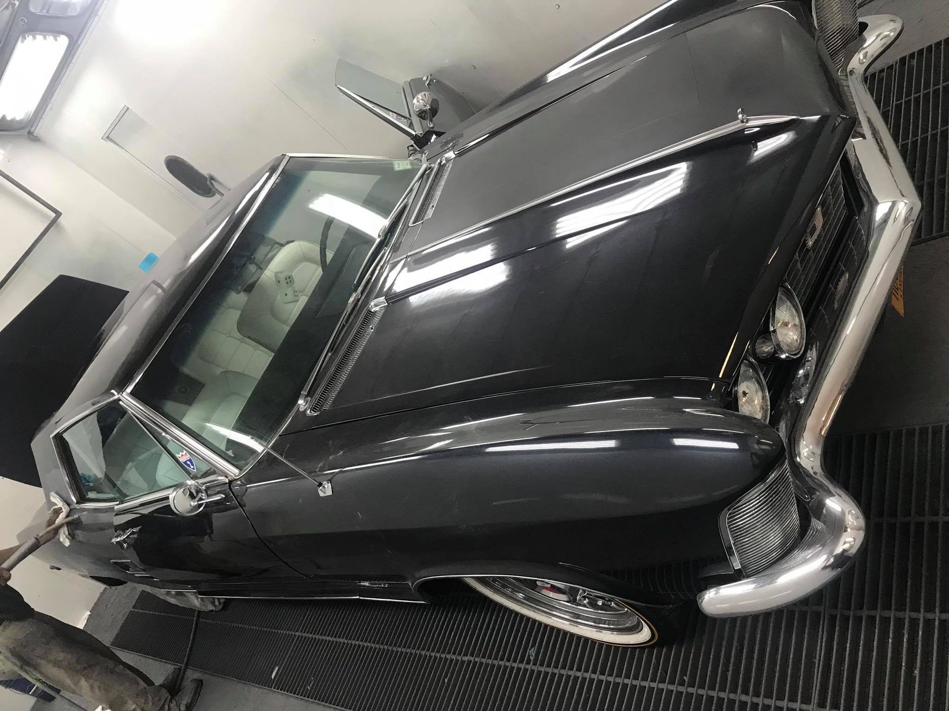 A black car is parked in a garage.