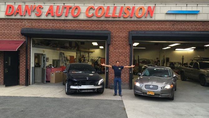 A man stands in front of a dan 's auto collision garage