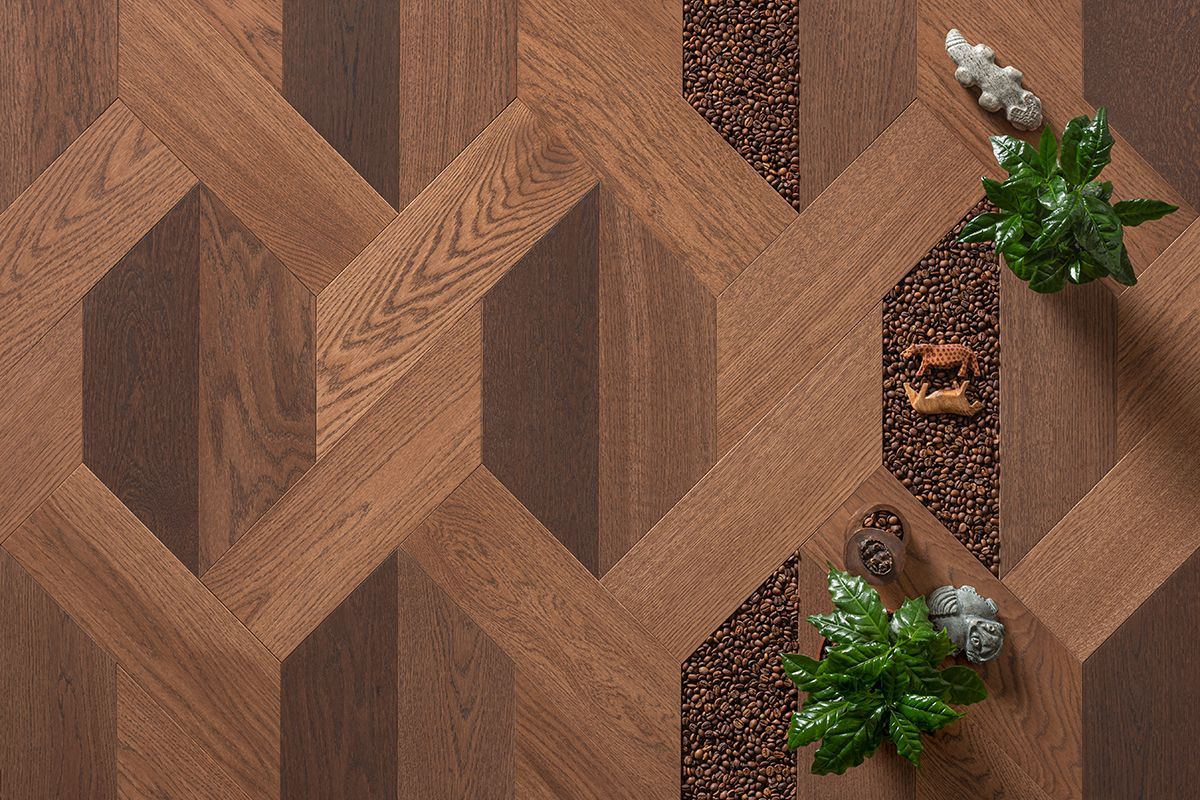 Wooden floor with geometric pattern, textured brown, and inlaid stone strip with plants and decor.