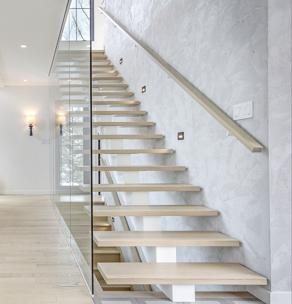 A staircase with wooden steps and a glass railing