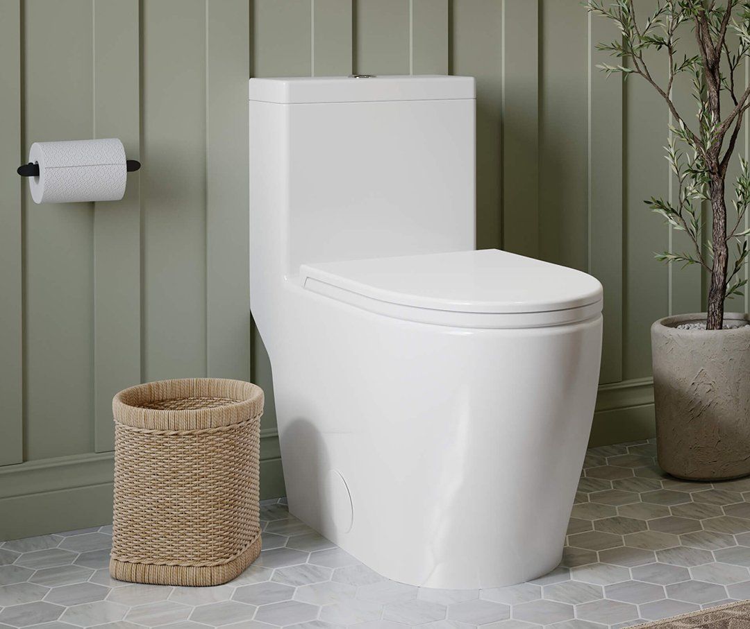 A white toilet is sitting in a bathroom next to a wicker basket.