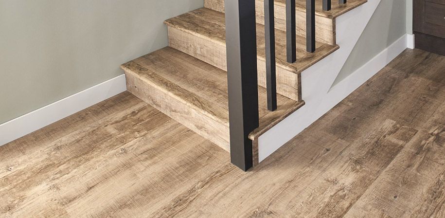 A staircase with a wooden floor and a metal railing.