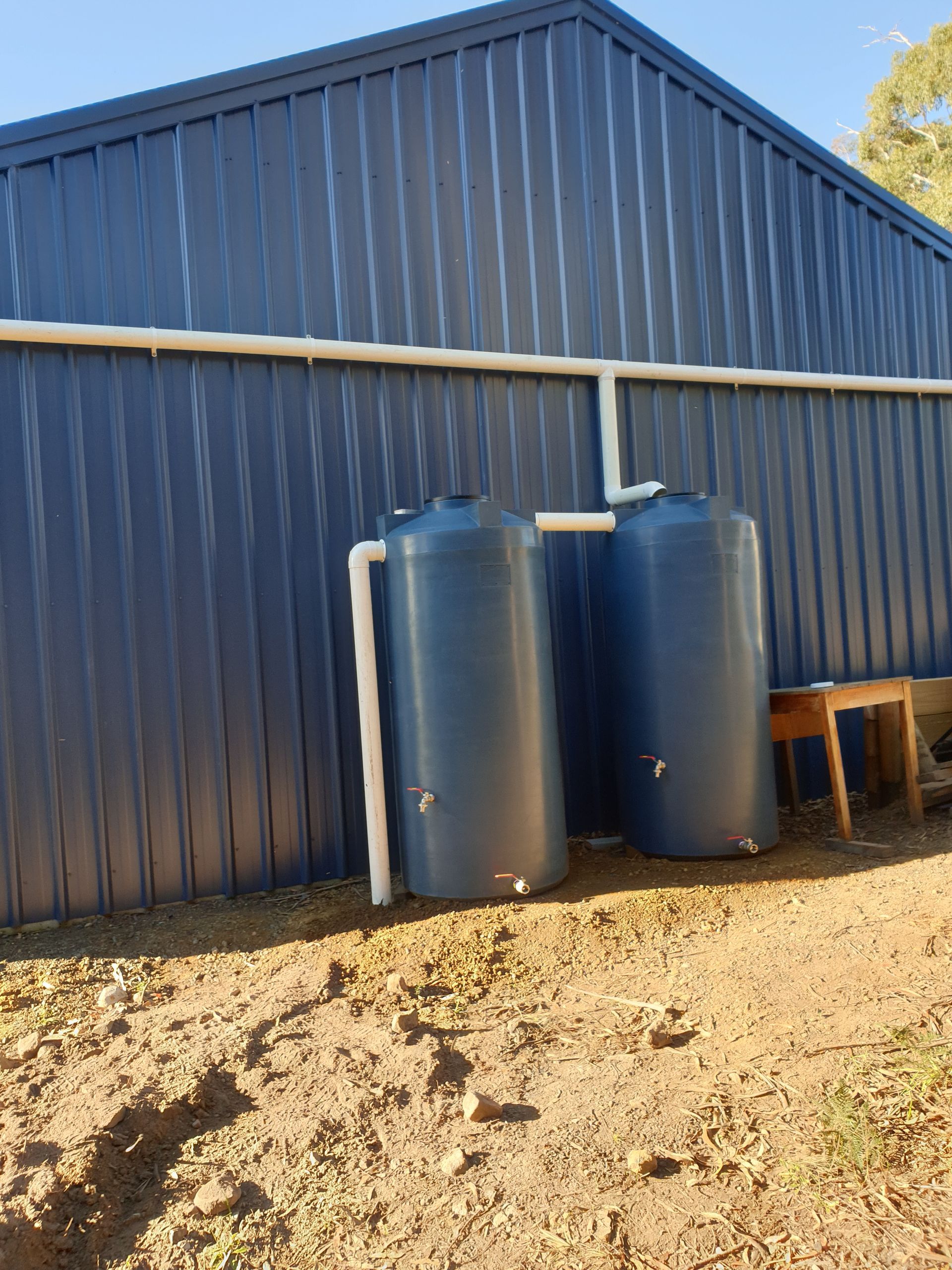 A Patio With a White Wall, Two Windows Featuring Striped Green — Lenny's Plumbing & Contracting in Granton, TAS