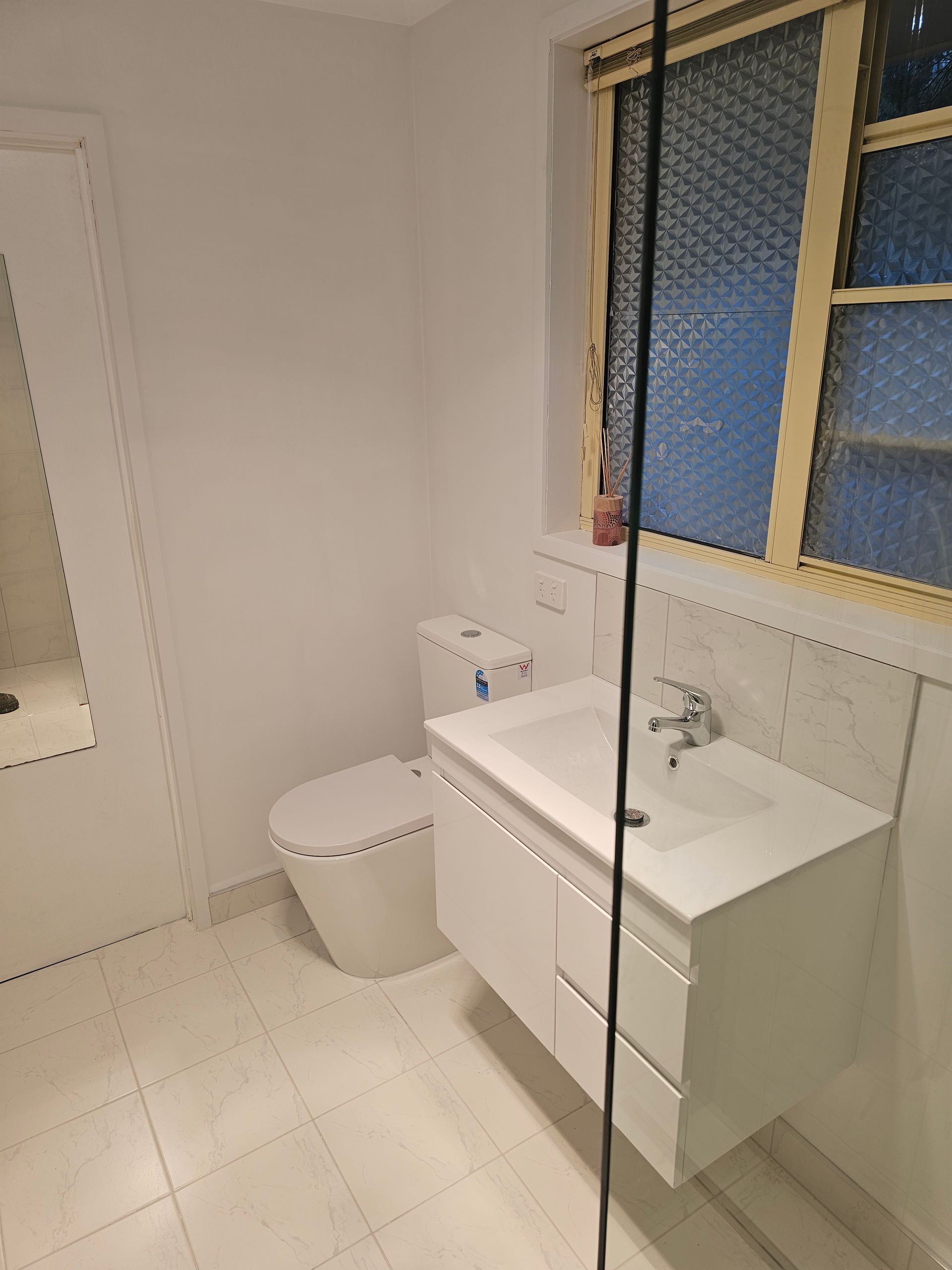 A bathroom featuring a white floating vanity with a sink — Lenny's Plumbing & Contracting in Granton, TAS
