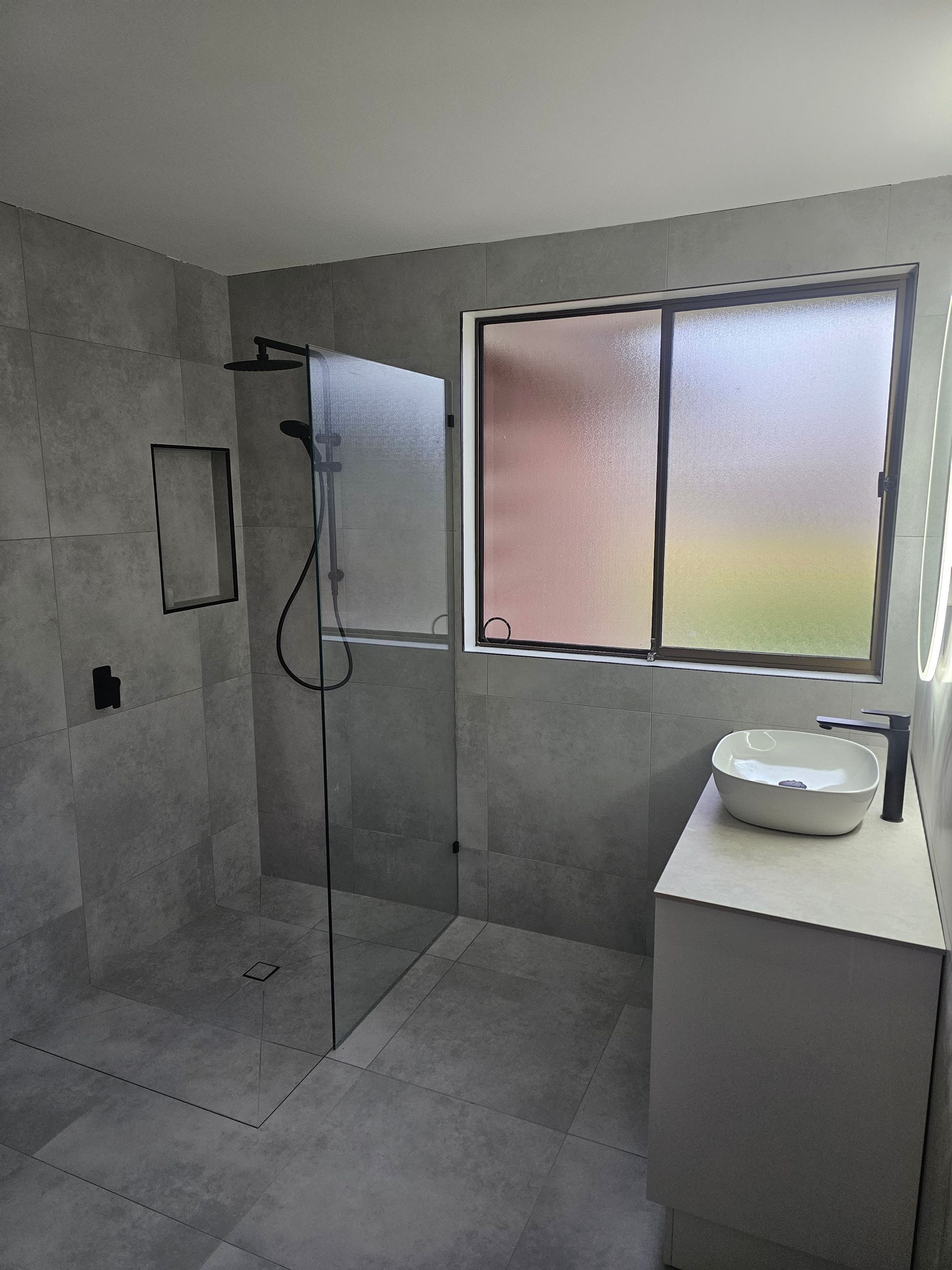 A modern bathroom with a glass-enclosed shower — Lenny's Plumbing & Contracting in Granton, TAS