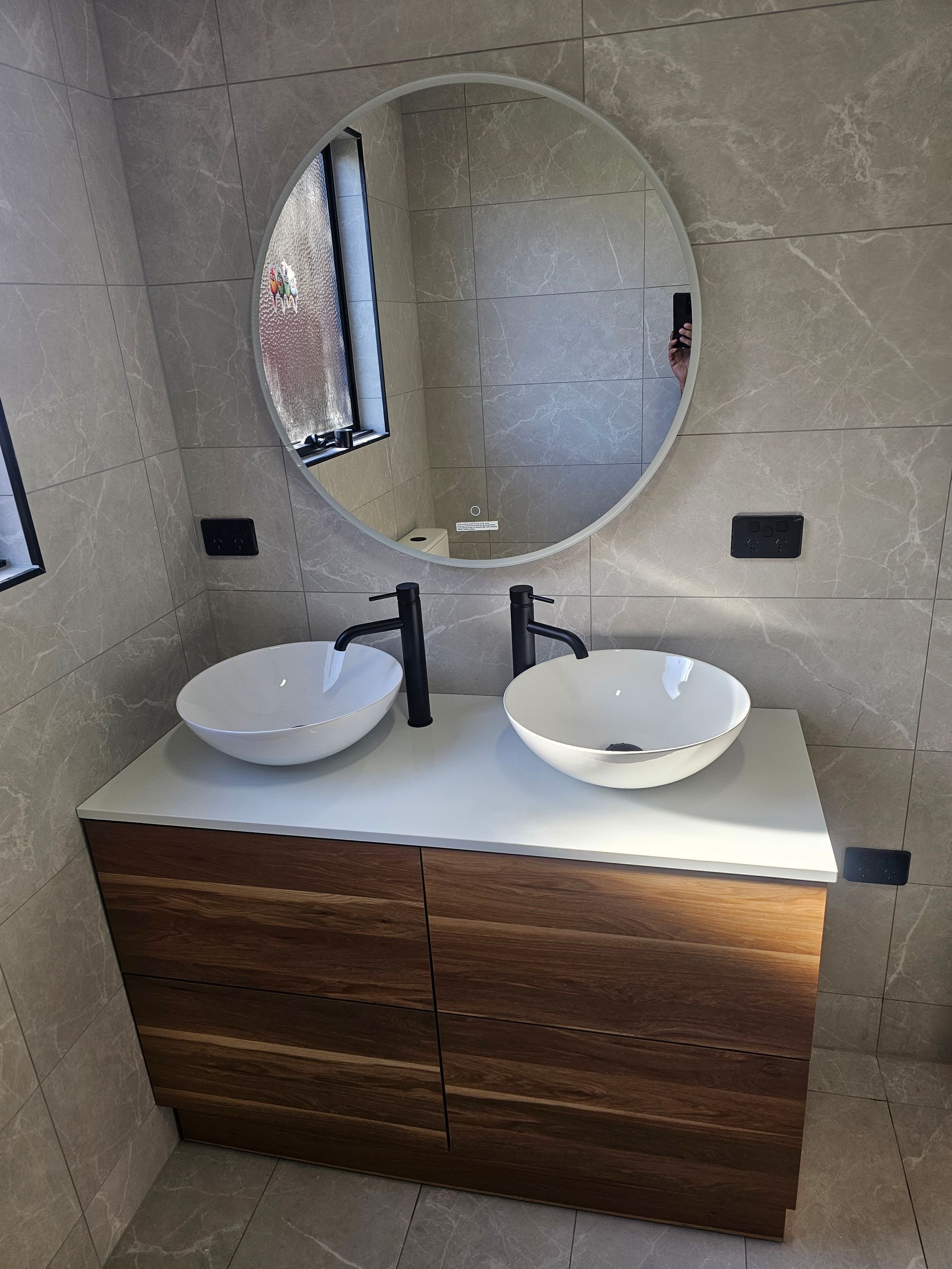 A bathroom vanity with a white countertop — Lenny's Plumbing & Contracting in Granton, TAS