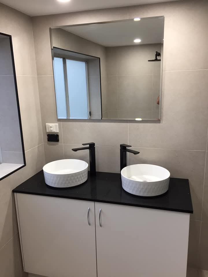 A Brightly Lit Bathroom With a Shower Stall on the Left — Lenny's Plumbing & Contracting in Granton, TAS