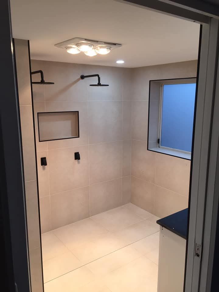 A Modern Walk-in Shower With Light Beige Tiles — Lenny's Plumbing & Contracting in Granton, TAS