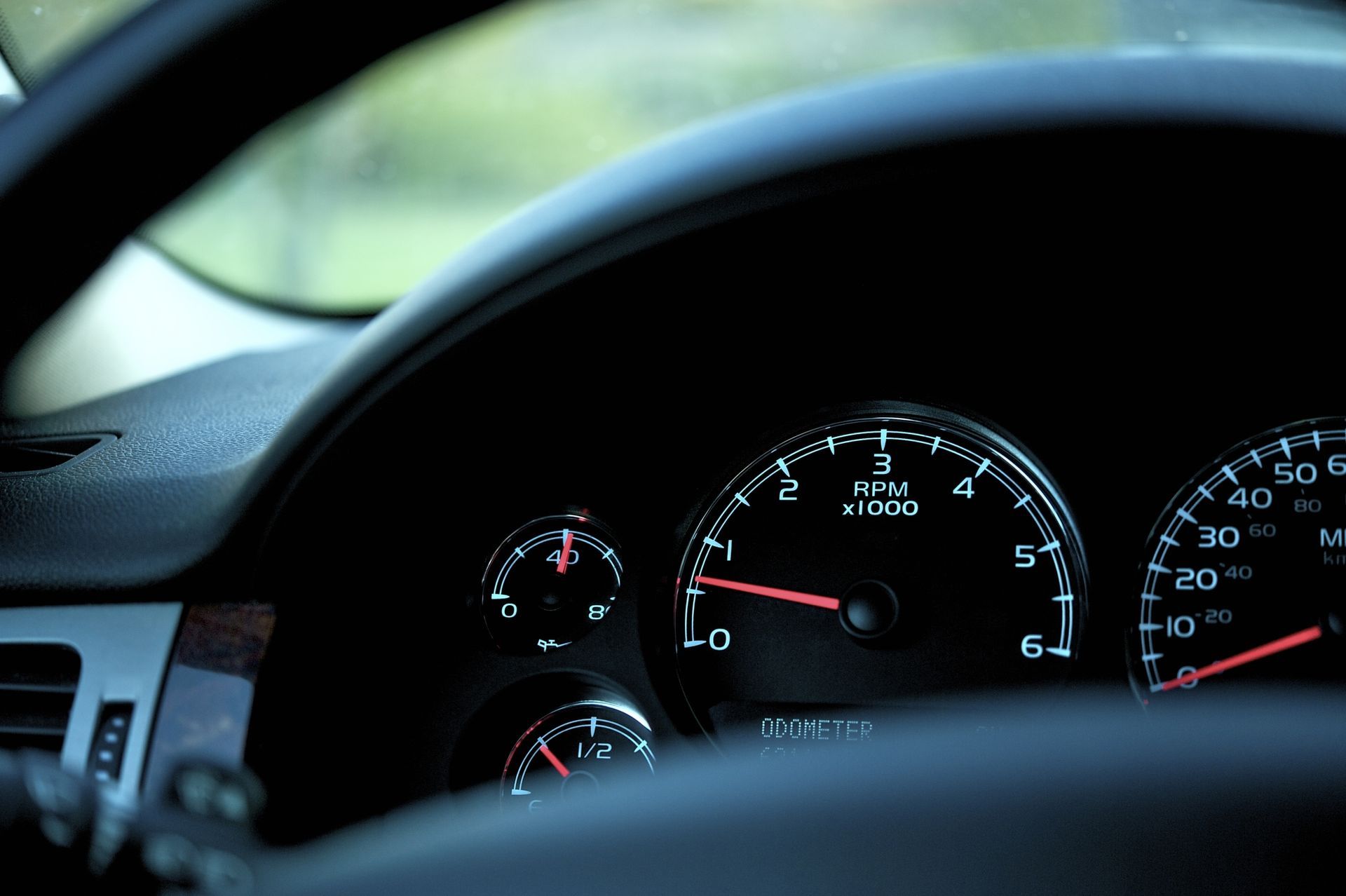 A close up of a car dashboard with a speedometer that reads 5 mph