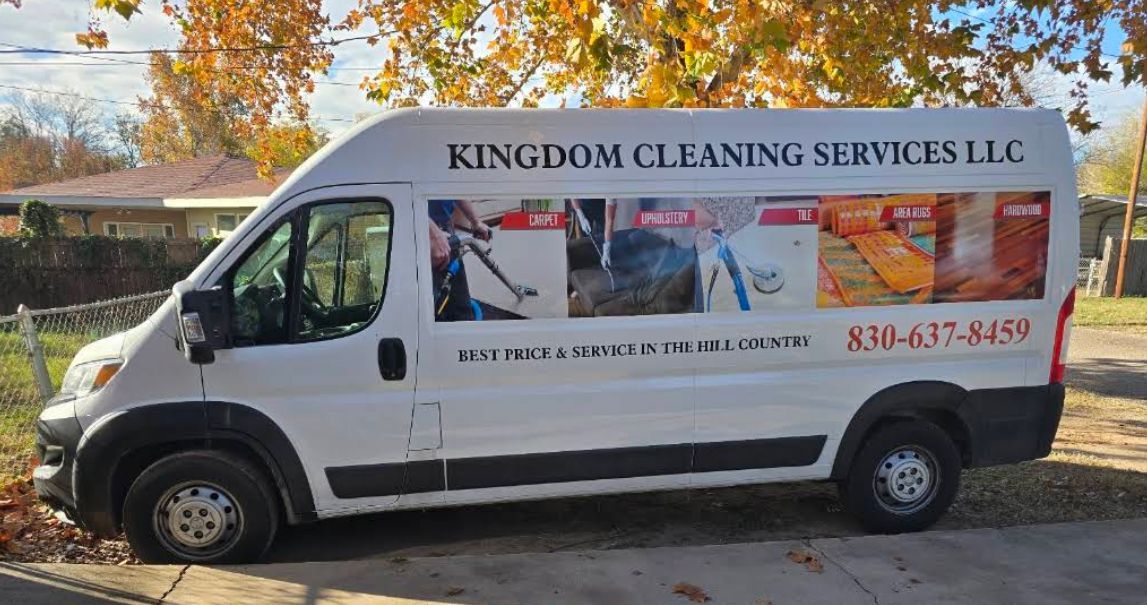 White Kingdom Cleaning Services LLC van parked on a street with autumn trees in the background