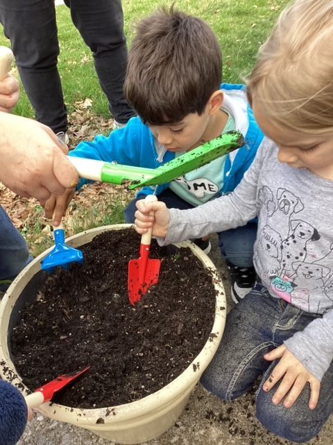 Image of children working in a plant container