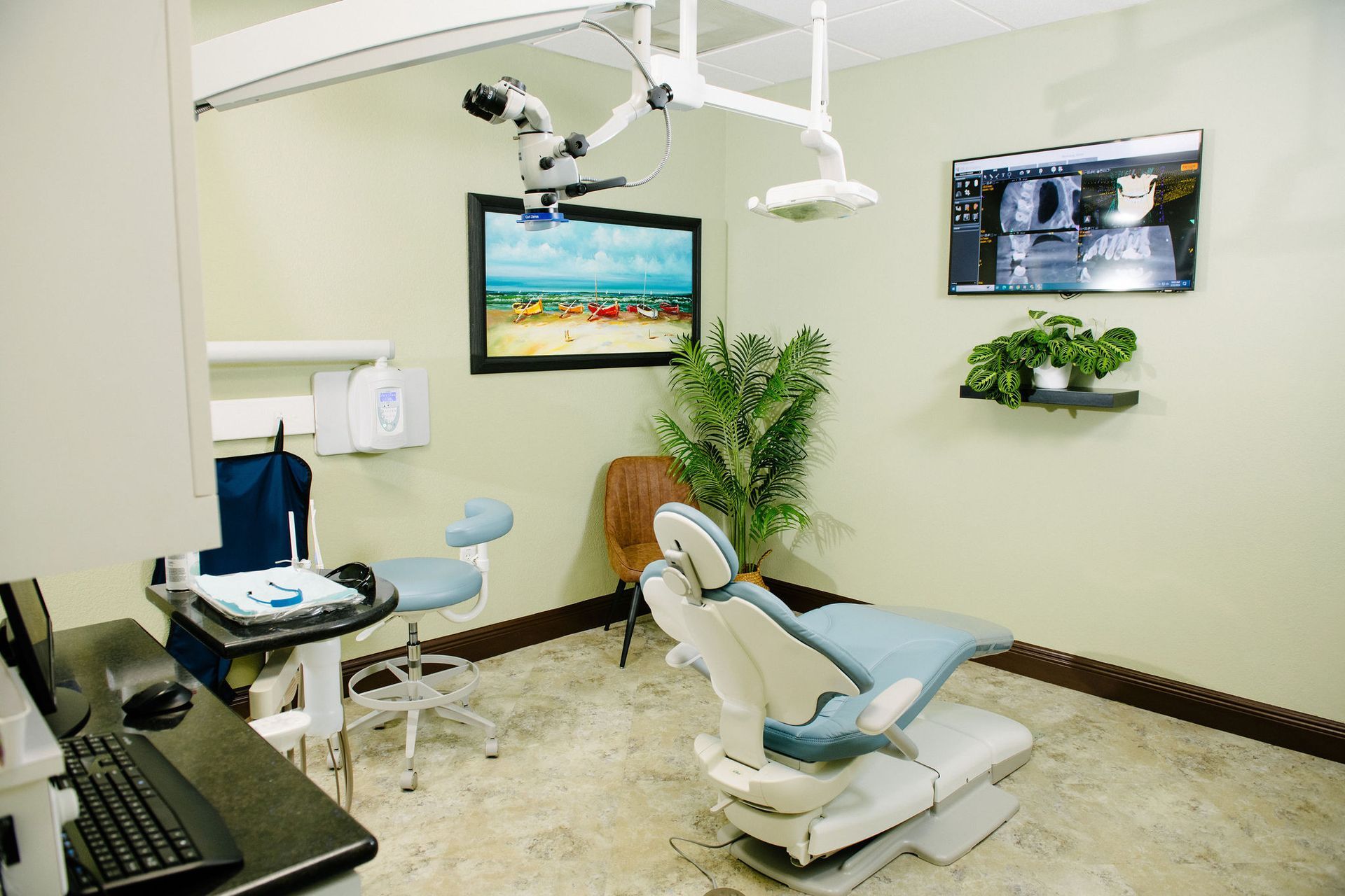 A dental office with a dental chair and a microscope.