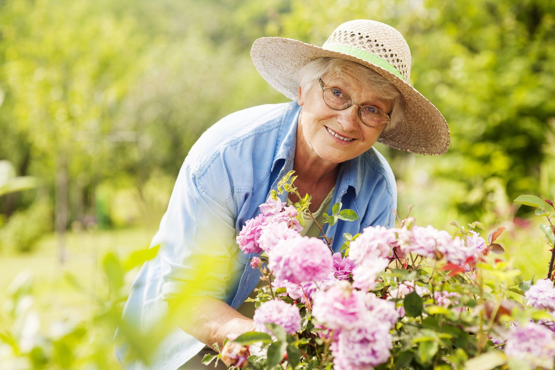 Senior Woman with Flowers in Garden — Dallas, TX — Kristi’s Senior Solutions