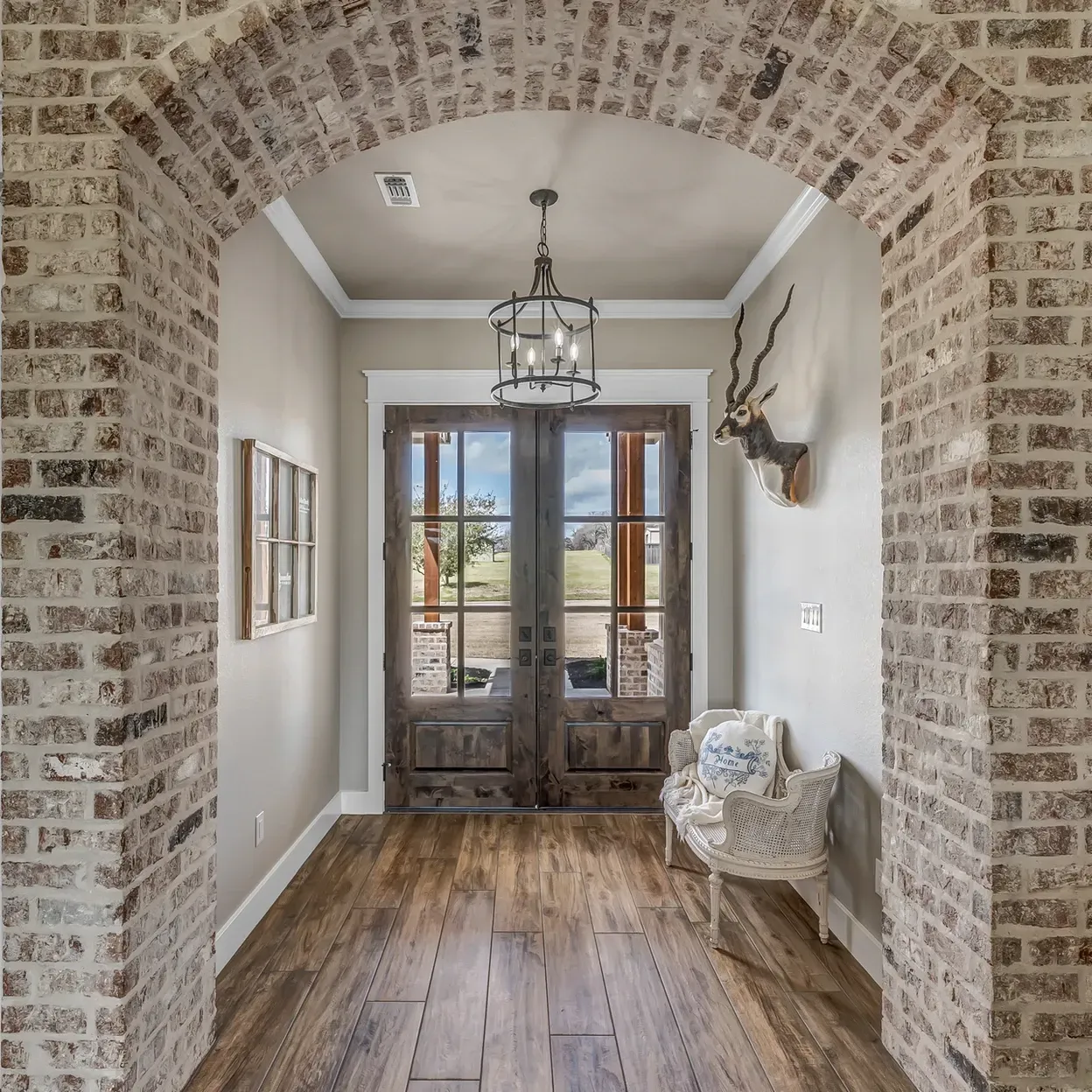 A hallway with brick walls and wooden floors